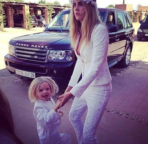 Cara resumed her role as bridesmaid and babysitter in a white lace Pucci suit.