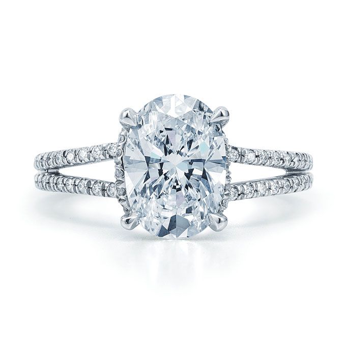 Oval diamond center stone and a split pave band.