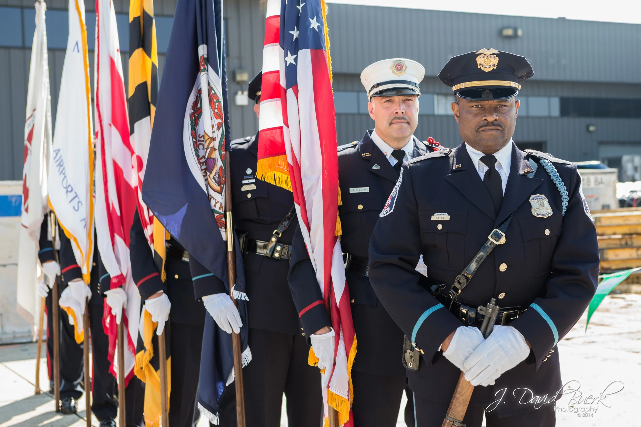 Fire and Police Officer Color Guard stand at the ready during the Opening Ceremony of 2014's Dulles Day Plane Pull and 5K / 10K on the Runway.