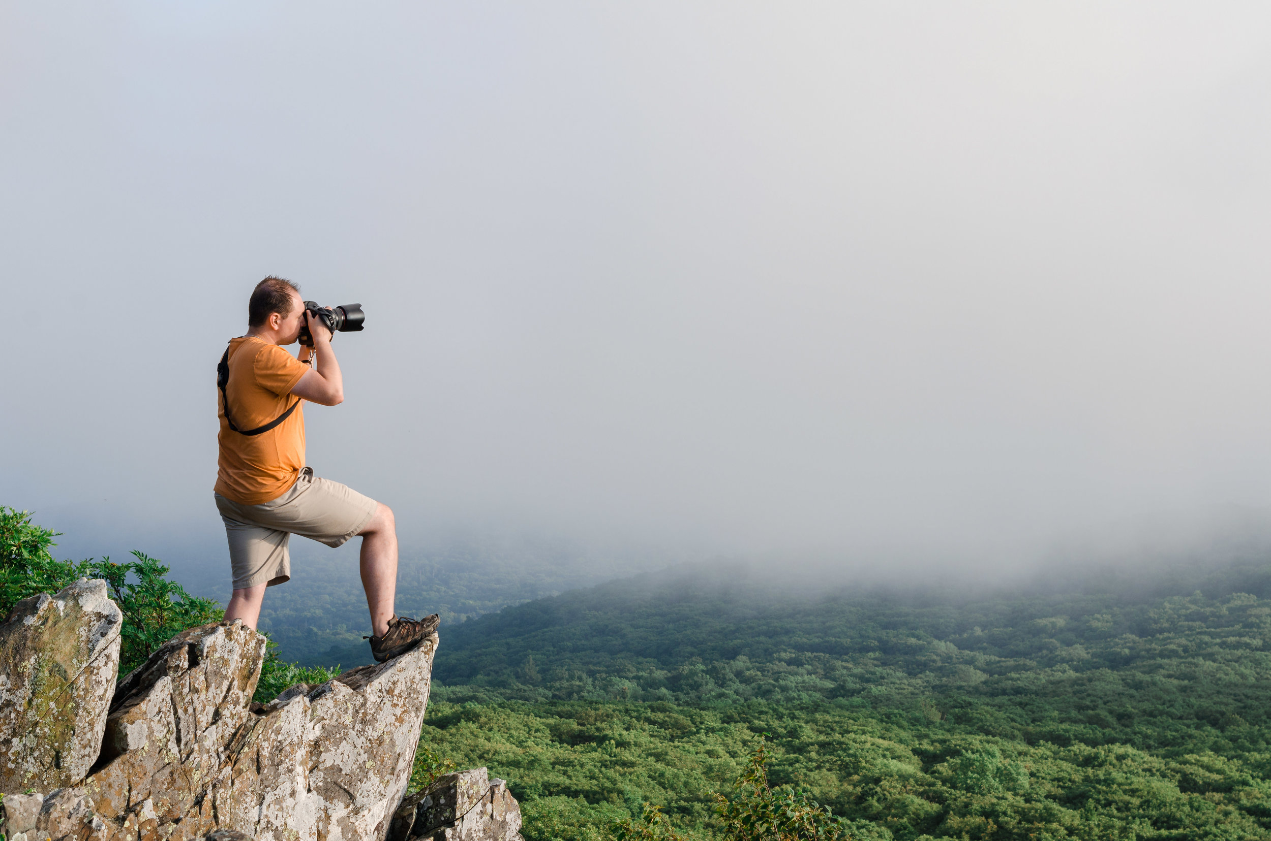Portrait of J. David Buerk, Washington, DC area commercial photographer, photographed by Alyssa McGuire atop Stony Man Mountain in Shenandoah, Virginia. Photo by Alyssa McGuire, edited by J. David Buerk.