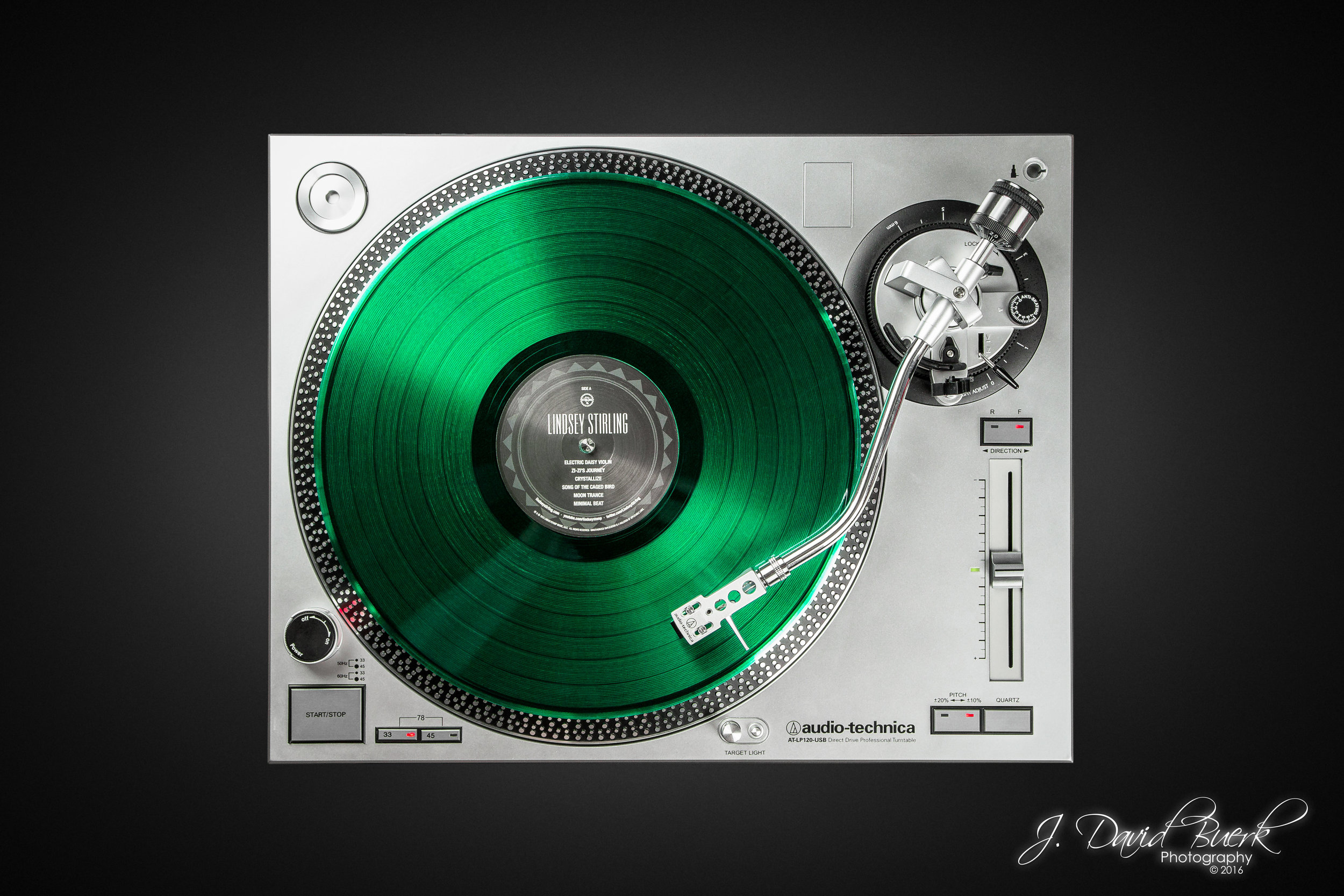 A Translucent Green Lindsey Stirling eponymous LP 33 RPM vinyl on an Audio-Technica turntable. 