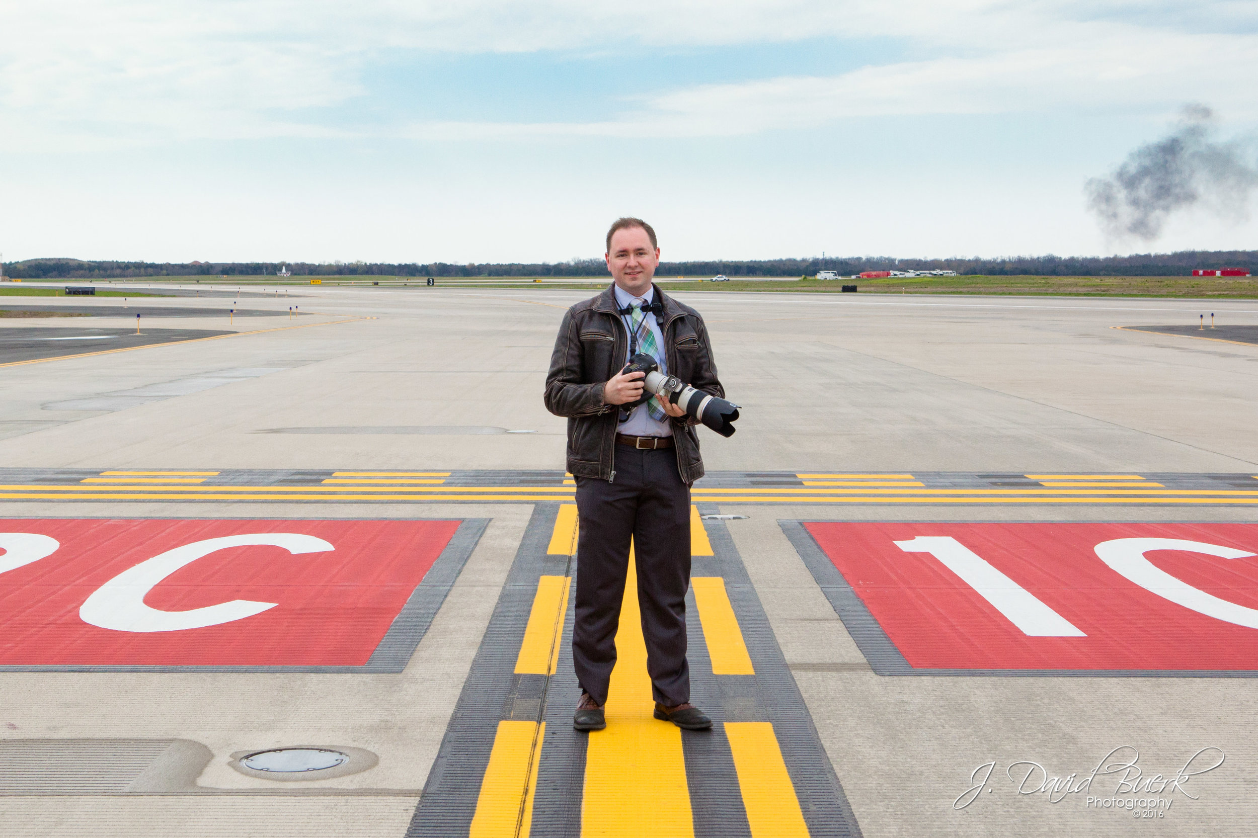 J. David Buerk, Washington, DC area commercial photographer, on Washington Dulles International Airport's R/W 1C high-speed hold-short line while photographing on assignment for the Metropolitan Washington Airports Authority during the All-Nippon Airways' "BB-8" Star Wars 777 event. Photo edited by J. David Buerk.