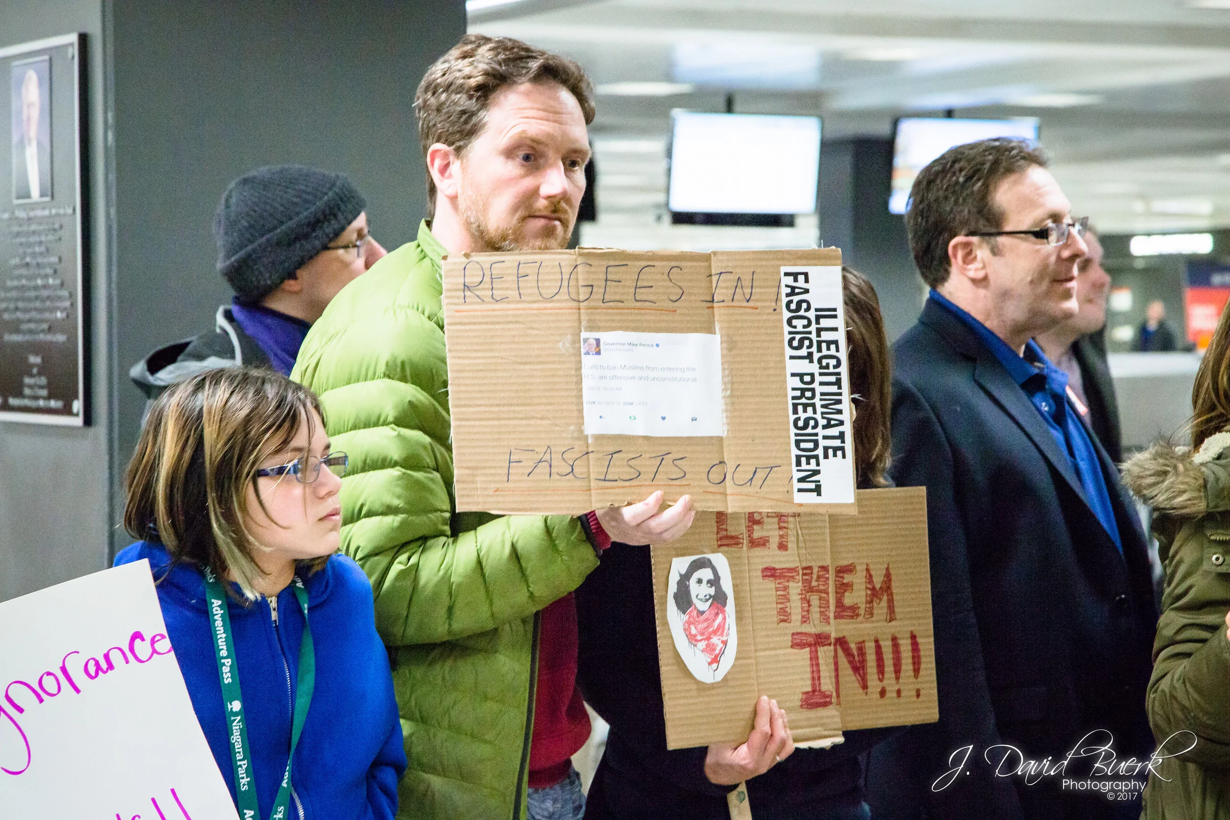 Vice President Mike Pence's December 8th, 2015 tweet, "Calls to ban Muslims from entering the U.S. are offensive and unconstitutional" printed on a protestor's sign; the widely circulated tweet is seen as directly contradictory to the Trump administration's travel ban rolled out just over a year later.