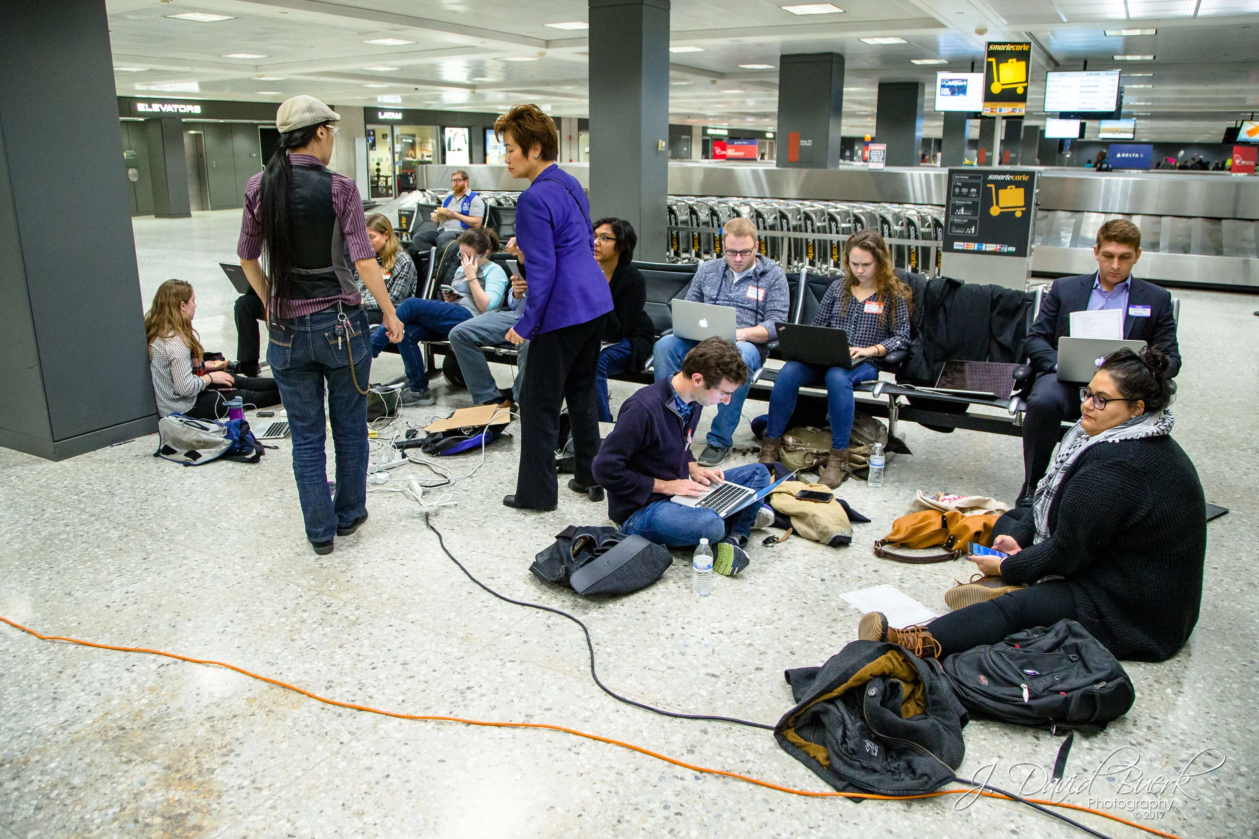 A group of volunteer lawyers working in the baggage claim area of Washington Dulles International Airport. When news of the travel ban broke on Saturday, lawyers, translators, and legal observers converged upon airports to donate their time and efforts in investigating and protecting against civil liberty violations.