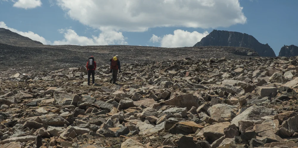 Endless fields of talus of the way to high camp. The summit of Granite Peak can now be seen in the distance.