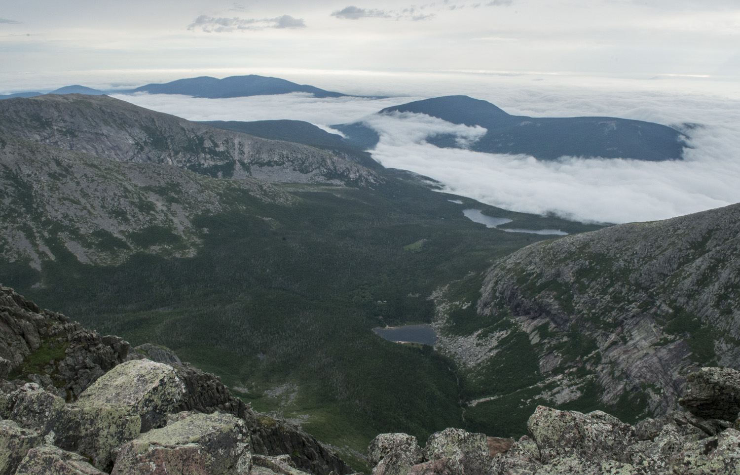 View from the summit. Chimney Pond is in the bottom middle, the Basin Ponds a little farther back, and then the fog filled lowlands.