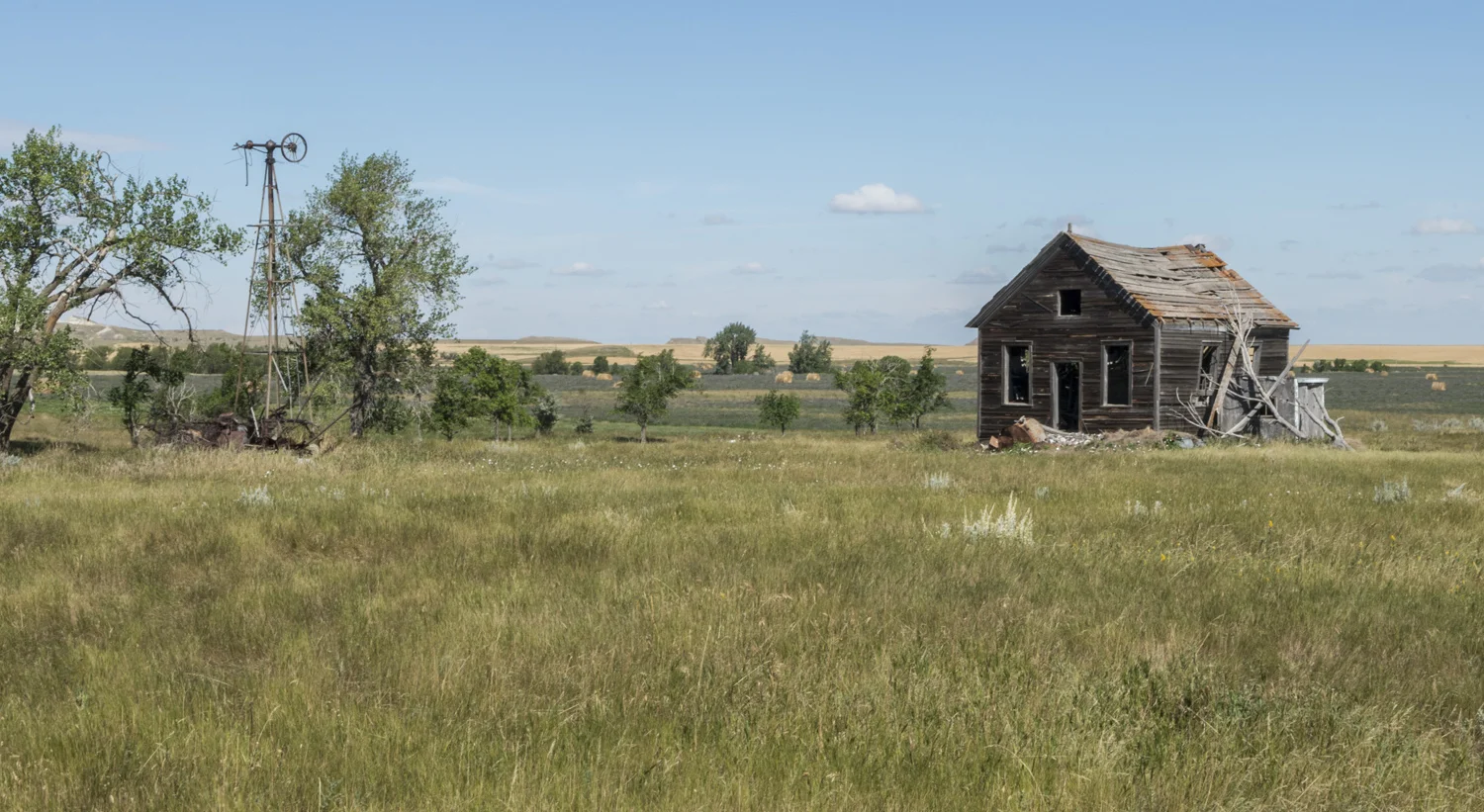 Abandoned farm house and windmill