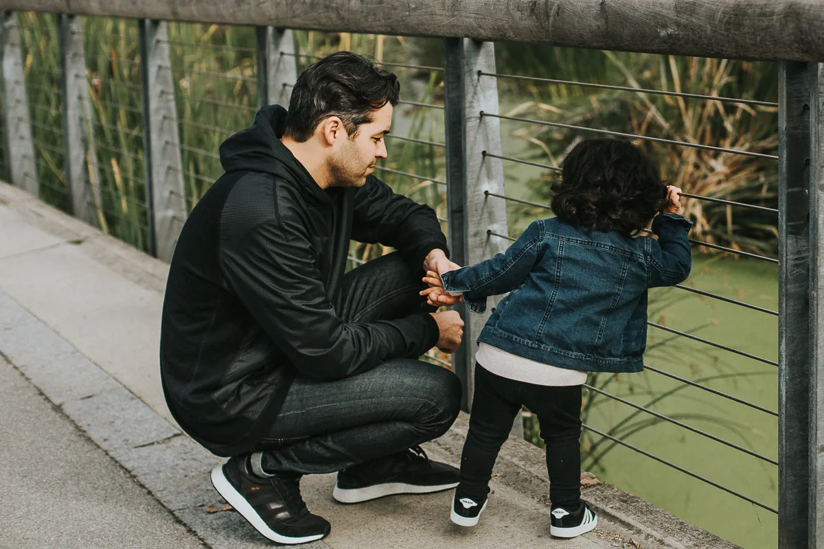 Father and son exploring creek together