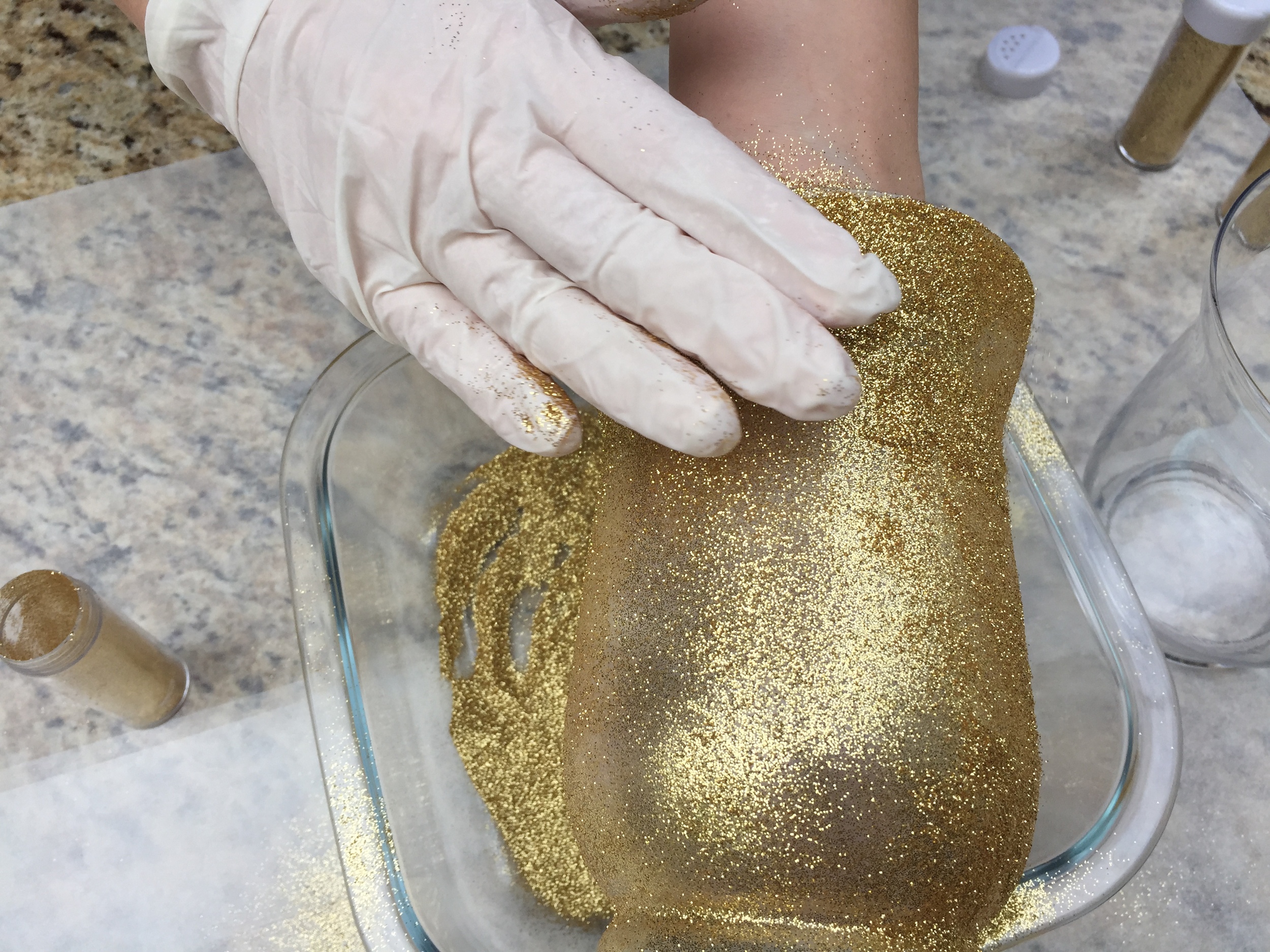 I kept applying the glitter until it is evenly spread by gently patting the glitter into the glue.