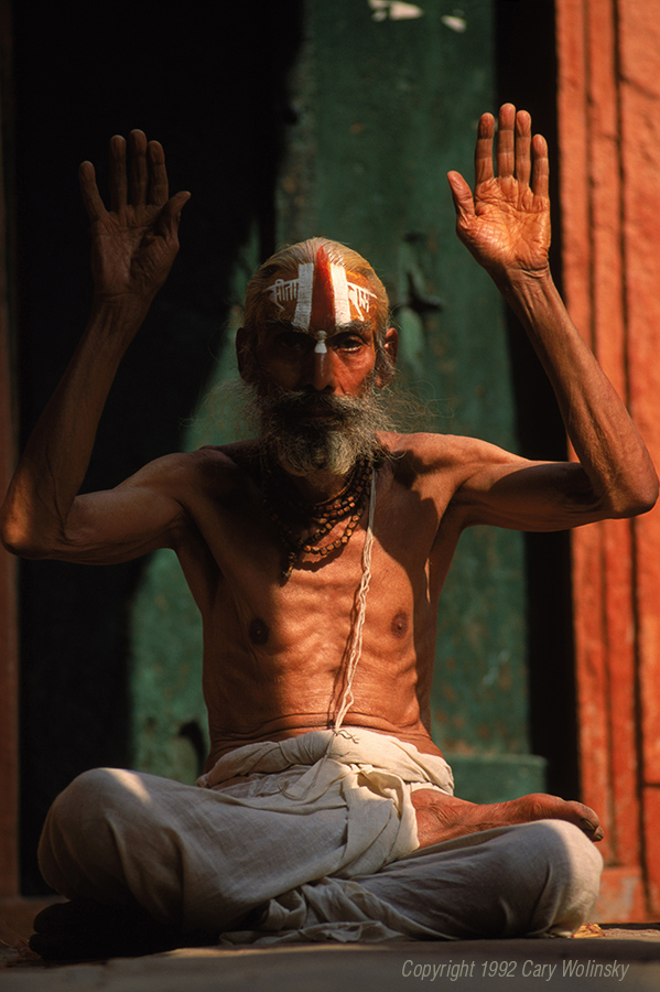An Indian holy man chants on the steps overlooking the Ganges River. He wears a cotton sutra, or sacred thread symbolizing the circle of life 