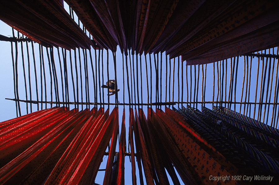 To qualify for government credits for low energy consumption, cotton printing factories in Ahmedabad, India air dry fabric by hanging it bamboo drying racks. 