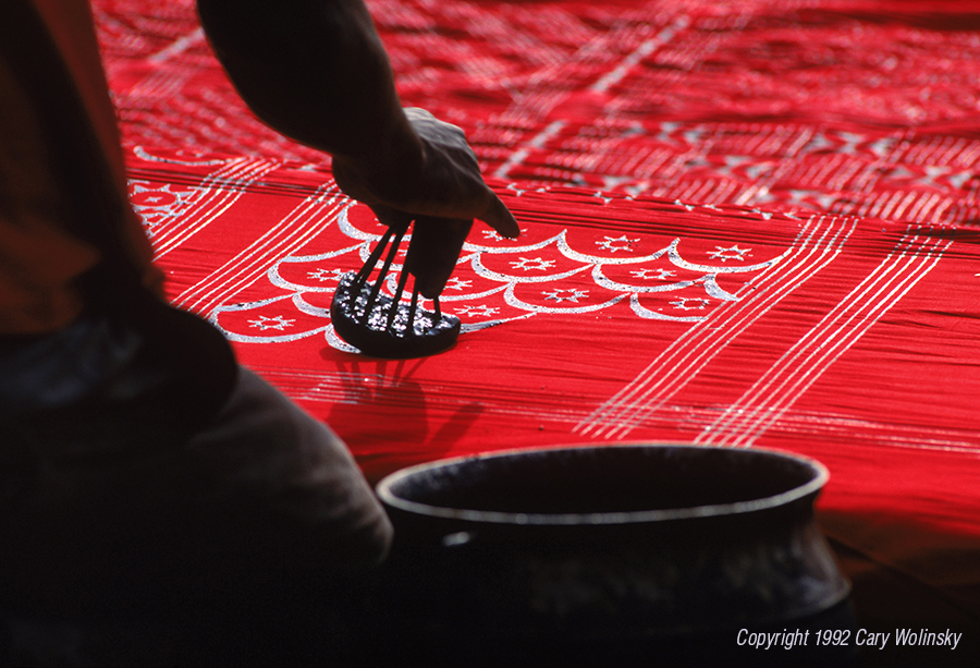 Hand printing an adinkra funeral cloth in Ghana, West Africa.
