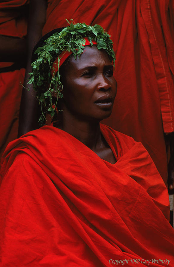 A woman wears red cloth to attend a funeral in Ghana, Africa. 