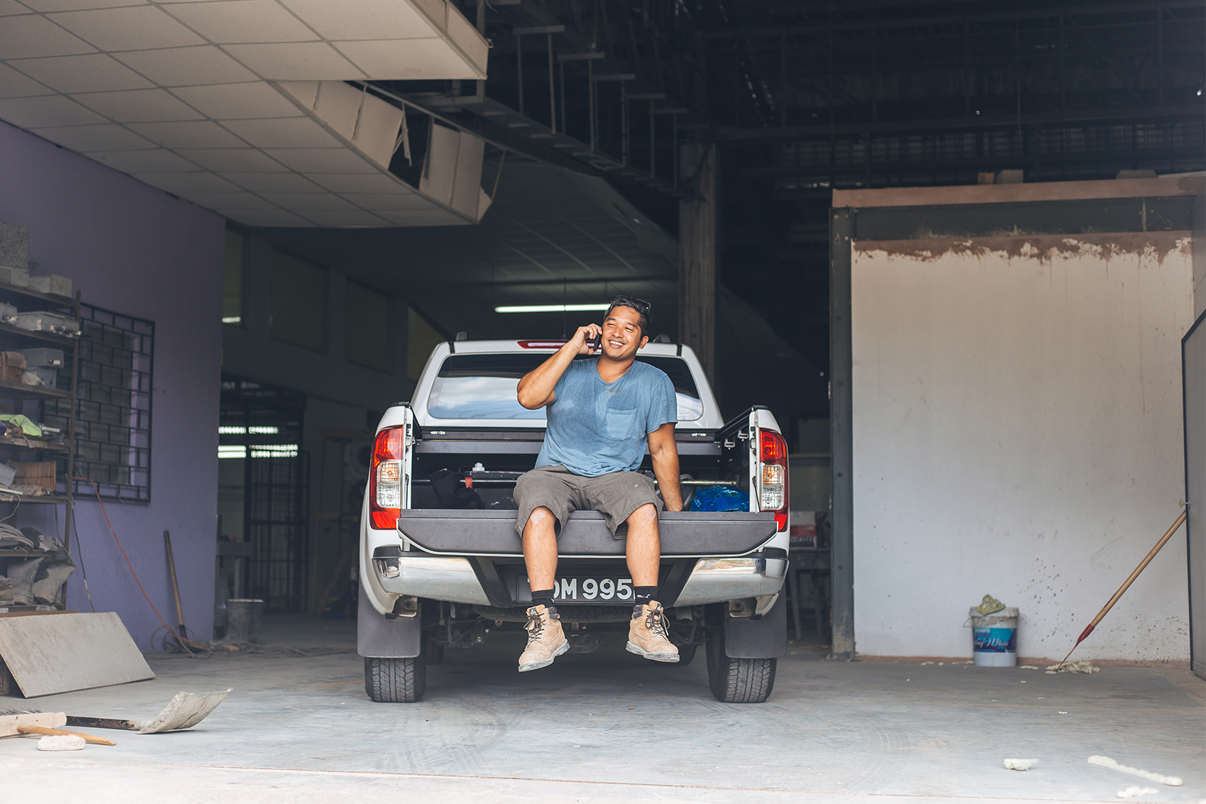 Marcus Sun Kow takes a call on a break from work at the new Fresh Start factory in Diamond Vale, Diego Martin. Last year Fresh Start secured financing to expand its operations after 23 years at its old location.