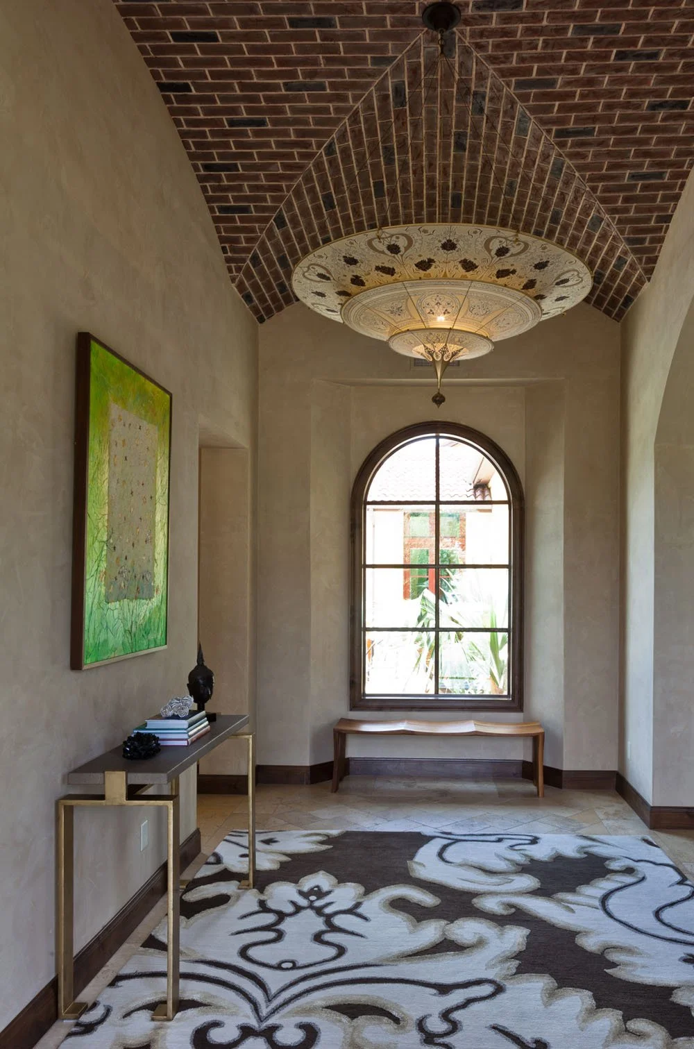  A gilded-steel console and sculpted walnut bench for Austin-based interior designer  Tracey Overbeck Stead  