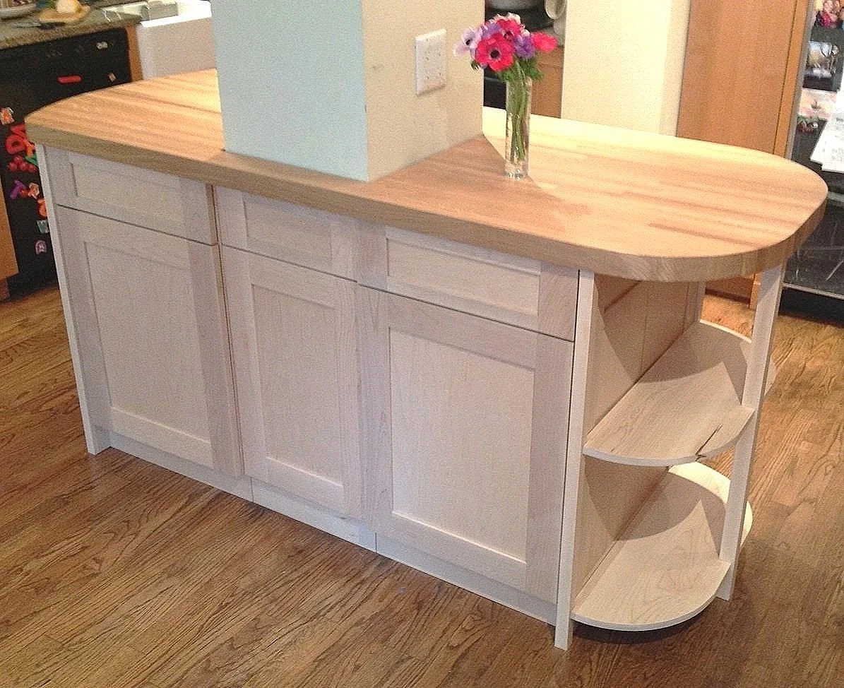  Designed and built around a critical apartment support column, an island that combined a functional butcher-block top and elegant maple base for a private NYC client 