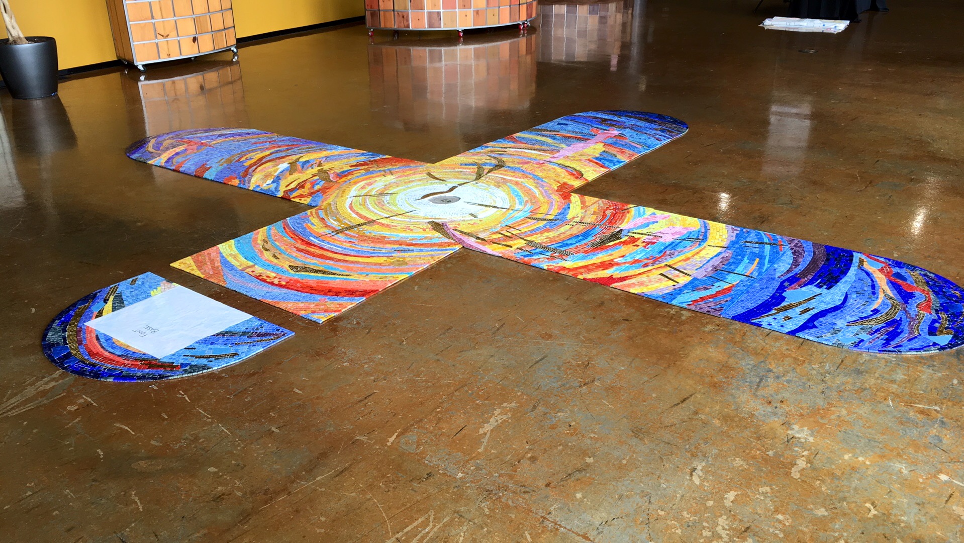 Laid flat, the mosaic will be installed with three steps on three sides of the font. A cast bronze font bowl will be placed over the white paper square on the lunette. (Vertical wall mosaic not shown, as it was still curing in the studio).