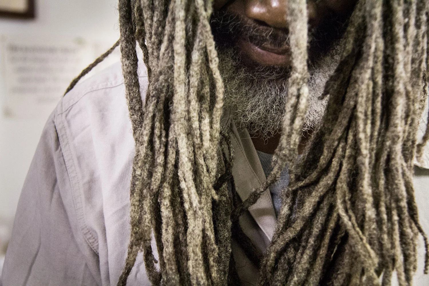Before facing the world and opening his store, Rivers Jordan puts his long dreadlocks into a hat as he claims that none of his friends have seen his hair. 