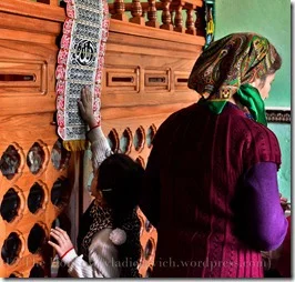 A girl touches a holy scroll covered in the names of Allah and the twelve Imams of Shiite Islam in Pensar, a small village in the south Azerbaijan, near the Iranian border.
