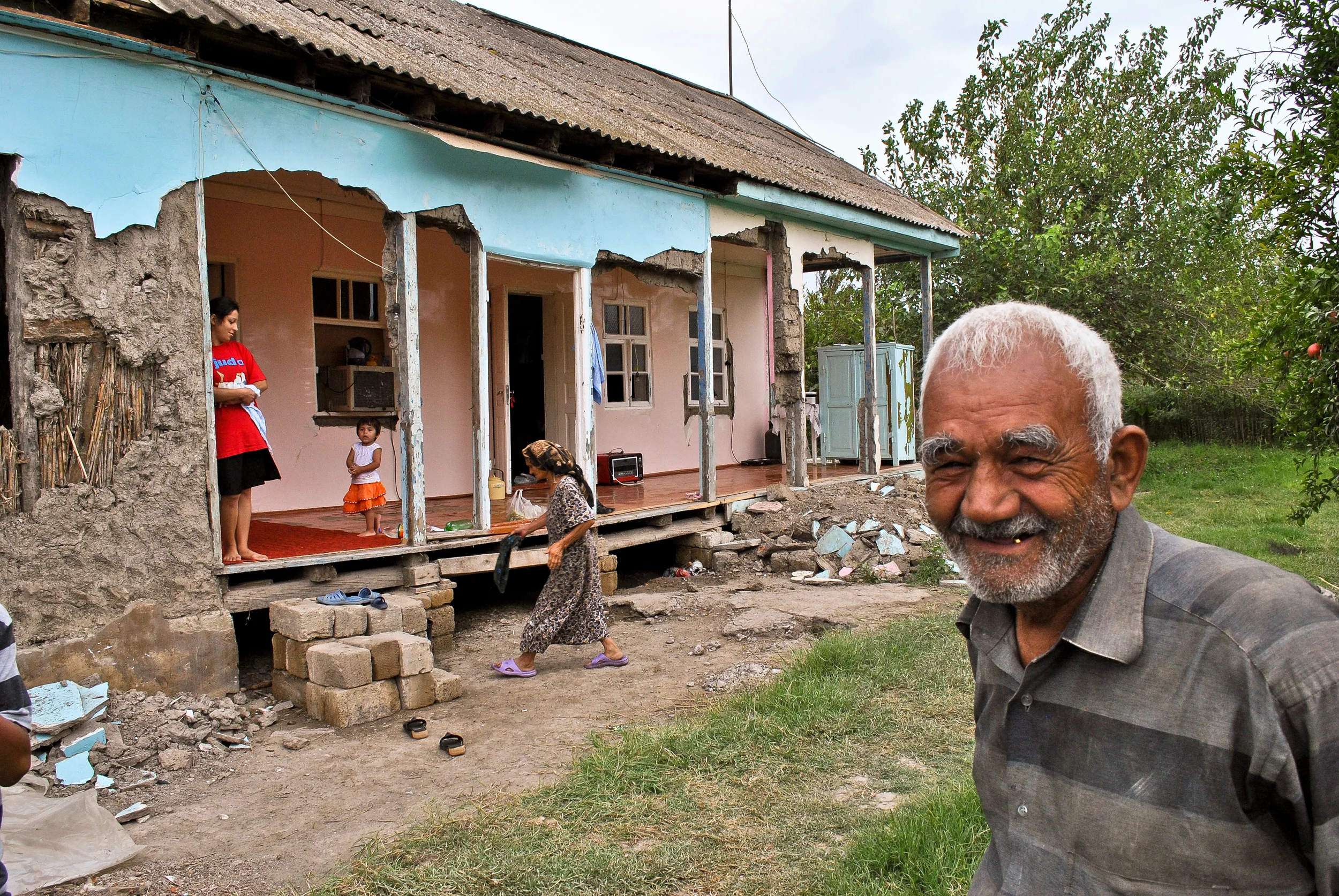 A resident of a small village near Sabirabad, with his flood ravaged home behind him.