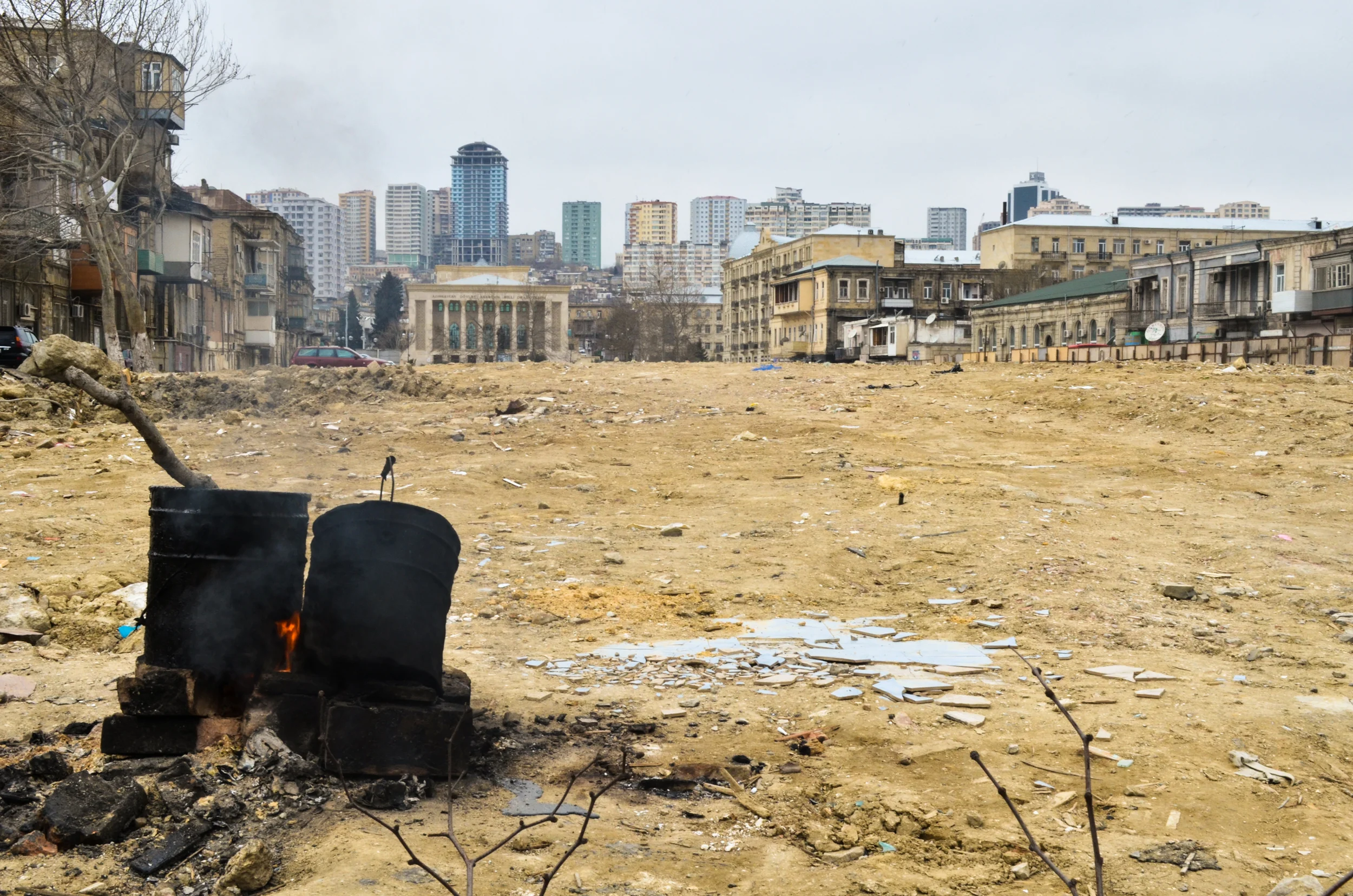 A bucket of tar warming over a flame in a recently demolished block near downtown Baku. Entire sections of the city are being cleared to feed the real estate demands of the recent oil and gas boom.