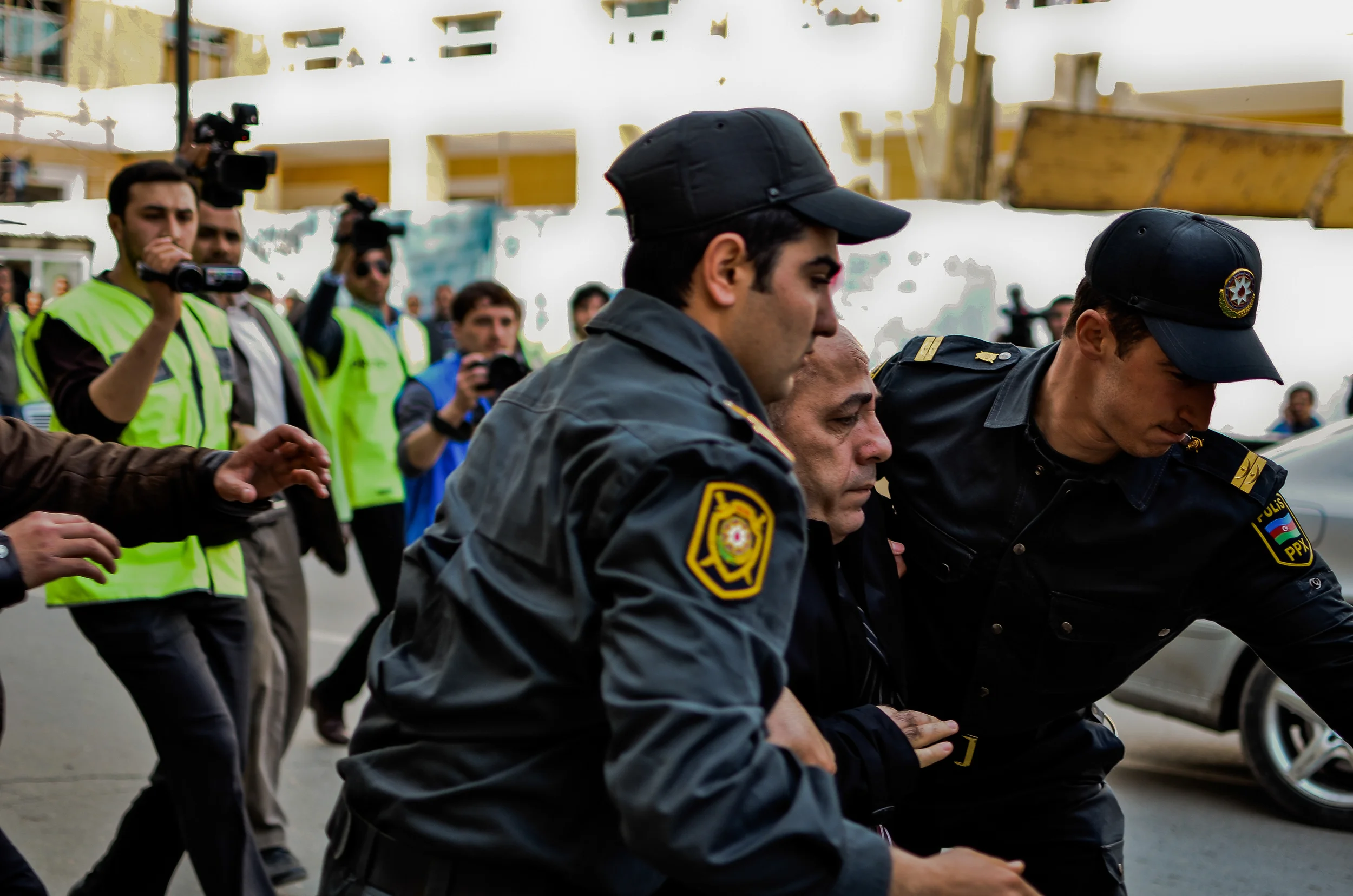 One of many people detained by Azerbaijani police during a recent protest rally that showed the weak state of both the opposition and free speech in Azerbaijan. While journalists were relatively free to document the arrests, a simple utterance of "freedom" or even no reason at all was sufficient for the police to forcefully seize and detain dozens of people.