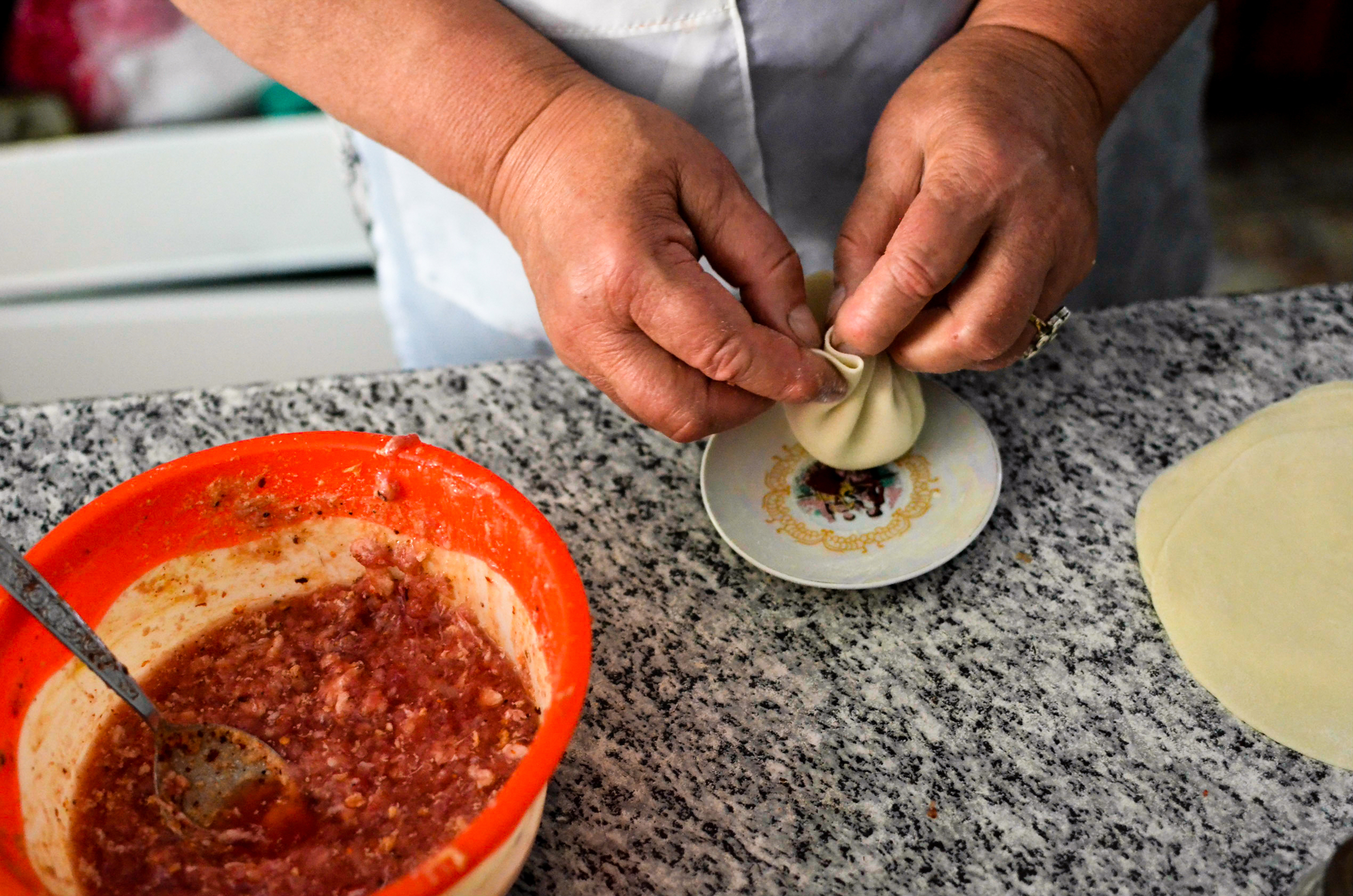 A woman makes khinkali in one of several restuarants converted from garages outside of Tbilisi.