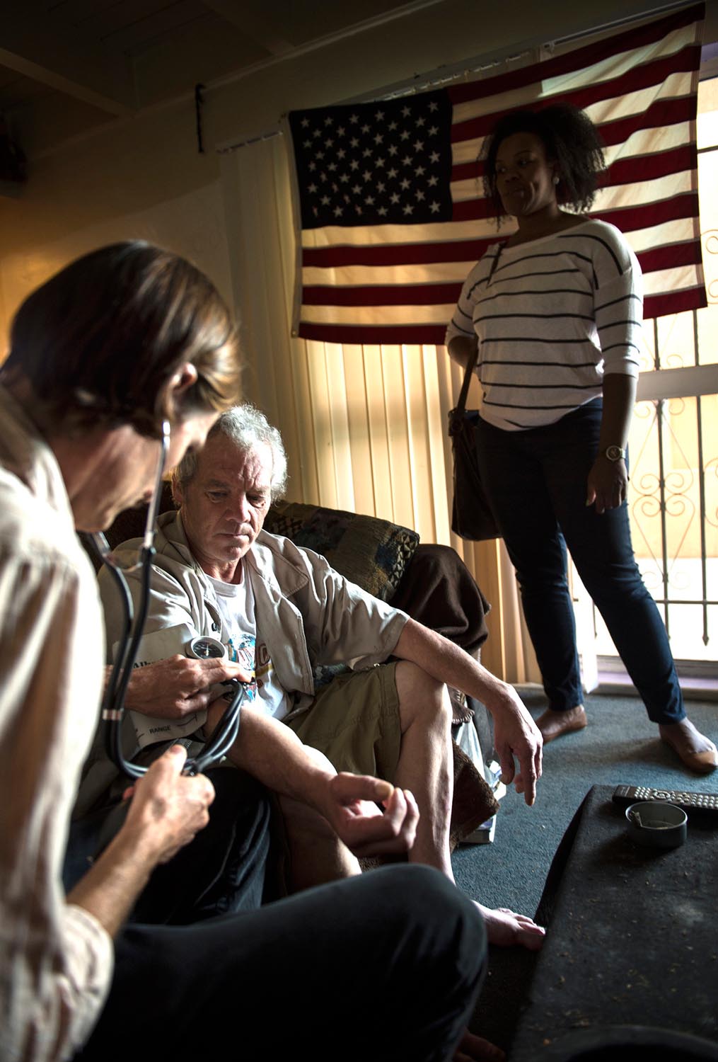 Dr. Coley King examines Kevin Peabody as Alexandria Thomas, mental health case manager with St. Joseph Center looks on at a supportive housing on Tuesday morning. Seven years ago Venice Family Clinic’s Dr. Coley King, and Isaiah Ortiz, case manager with (OPCC) Ocean Park Community Center, started their work in an emerging model of care known as street medicine.
