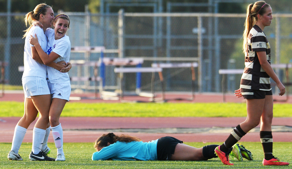  La Mirada's Madison Bennett(4) celabrates her game winning goal with teammate Aubrey Baran(28) as West Torrance's Ruth Soto, goal keeper,  lies on the ground in CIF State Division II first round high school girls soccer in La Mirada CA. Tuesday Marc