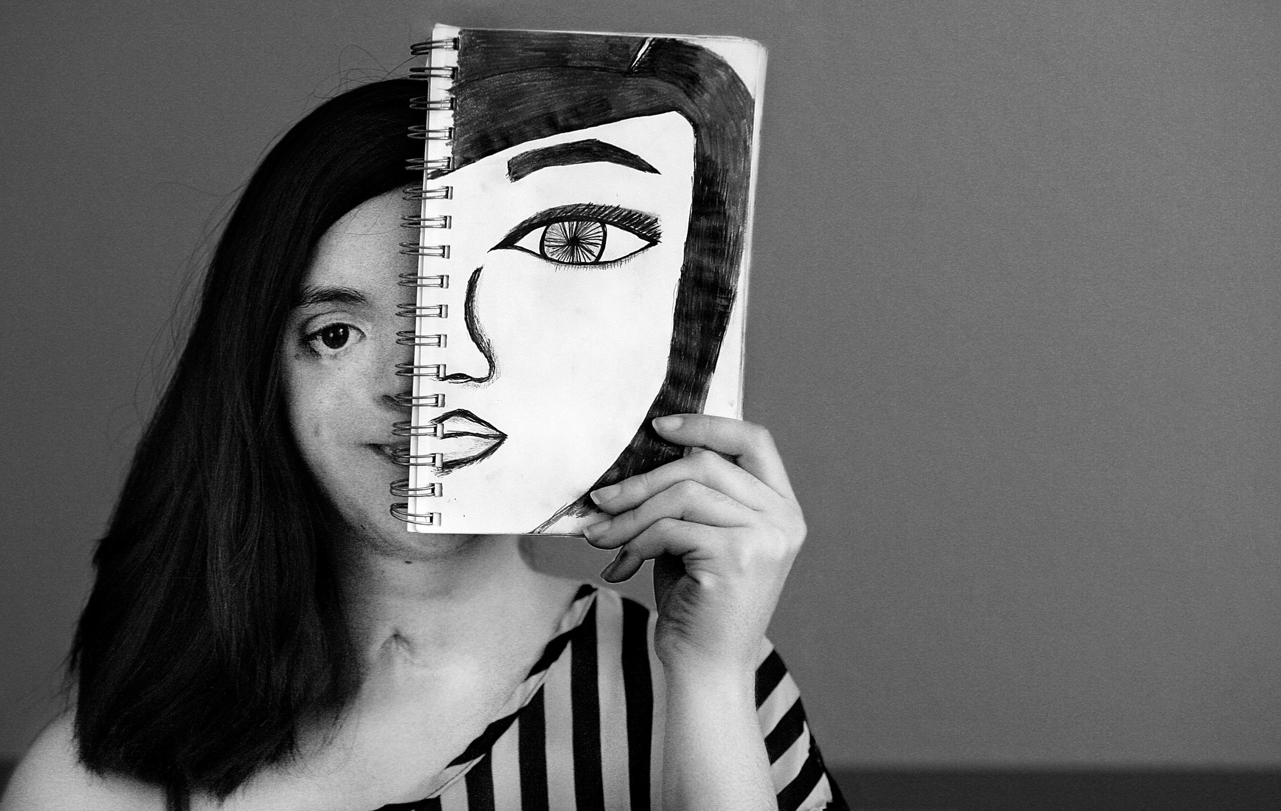  Lisa Encinas, 25, of Moreno Valley loves to draw with pencils and work with pastels in her art work, she is pictured with one of her many drawings on a sketch pad Tuesday in Moreno Valley, July 14, 2015. 
Encinas has Treacher's Collins syndrome, a b