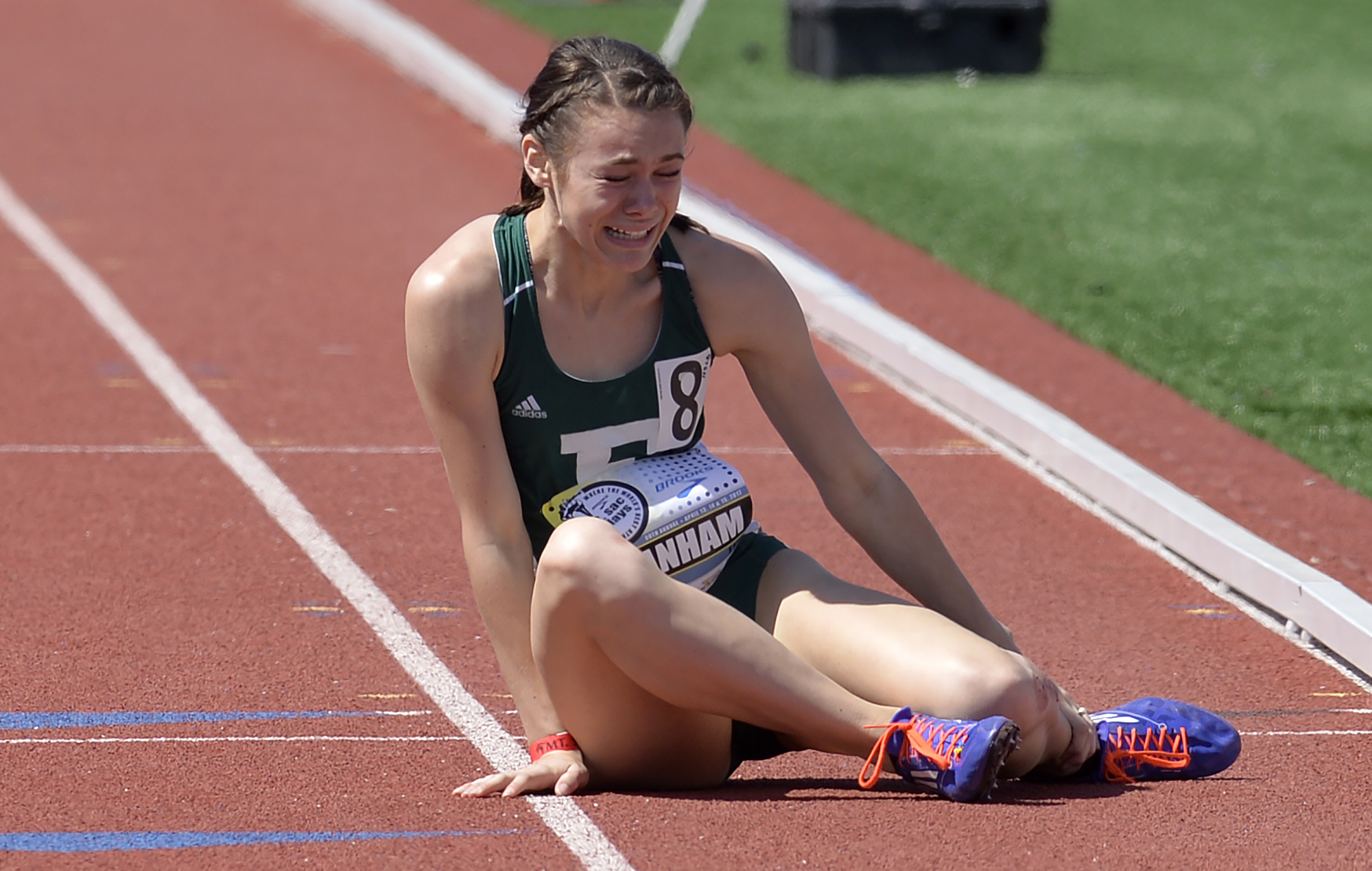  Rebekah Branham, of Eastern Michigan, lies on the track holding her injured ankle after stumbling in the 800m College Open Section 3  event at the Mt. SAC Relays at are El Camino College in Torrance Friday, April 14, 2017. 