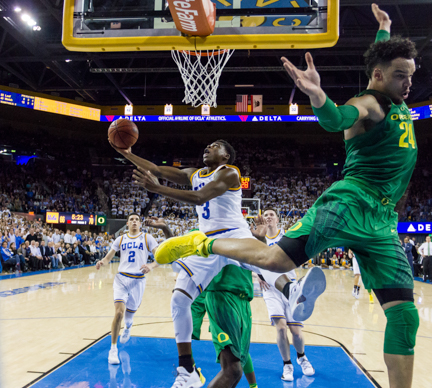 UCLA guard Aaron Holiday (3) pushes past Oregon forward Dillon Brooks (24) to score a layup at Pauley Pavilion in Los Angeles, Calif. on Feb. 9, 2017. Holiday's layup started a seven-point scoring streak for the Bruins that turned the lead to UCLA in the final minutes, winning them the game 82-79.