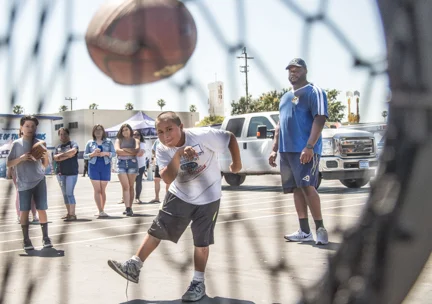 (Right) #67 Defensive Tackle, Omarius Bryant of the Los Angeles Rams playing with young fans at the Friday, June 16, 2017, 'Playground Build'. Figueroa Street Elemenyty School. 510 West 111th St., Los Angeles, California. Photo By: Daniel Bowyer