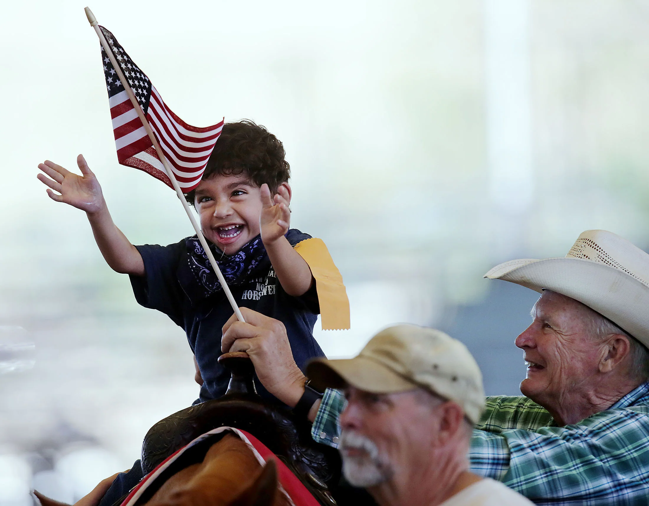 Giovanny Lizardi, 5, of San Bernardino enjoys a ride on a real horse as he reaches for a flag as he enjoys Challenged Children's Rodeo for special needs kids at Ingalls Park in Norco, CA. Sunday, Apr. 23, 2017.