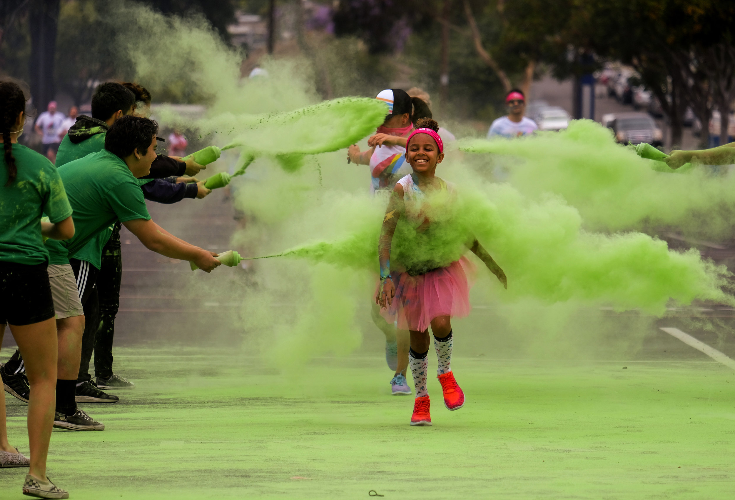  Runners revel while running through clouds of colorful powder thrown by volunteers in the Color Run at the StubHub Center in Los Angeles, United States, June 23, 2018.  