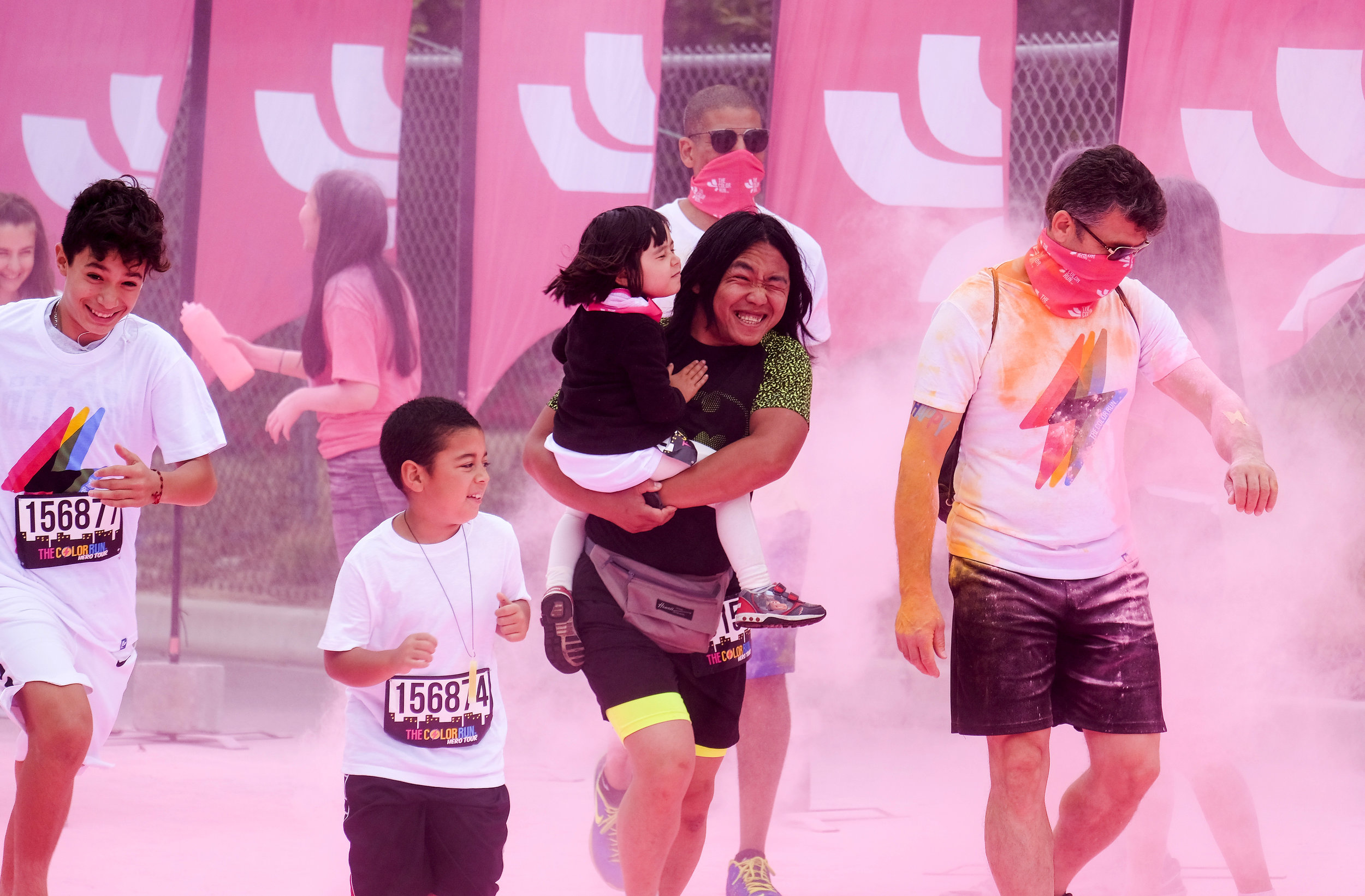  Runners revel while running through clouds of colorful powder thrown by volunteers in the Color Run at the StubHub Center in Los Angeles, United States, June 23, 2018.  