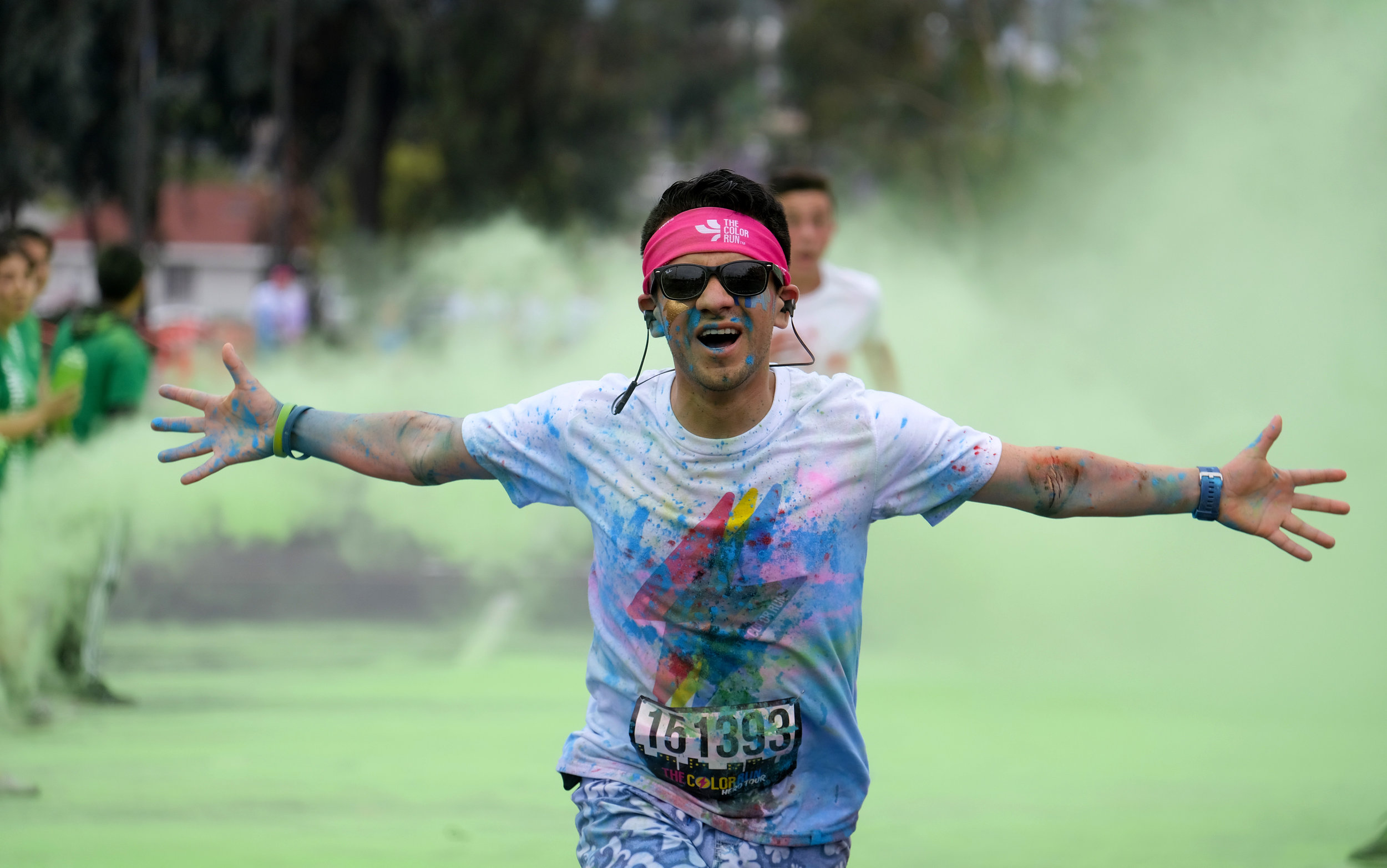  Running enthusiasts race through clouds of colorful powder thrown by volunteers during the Color Run at the StubHub Center, Saturday, June 23, 2018 in Carson, California.  