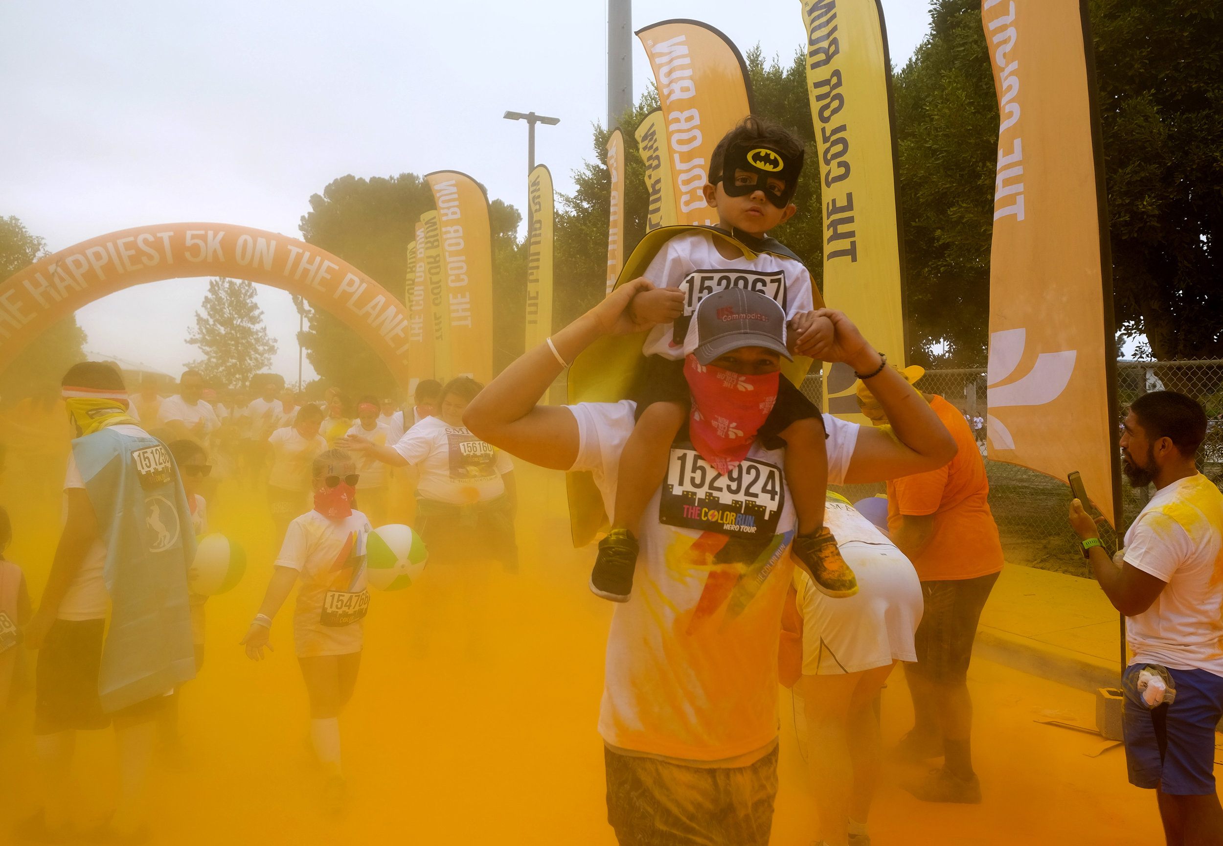  Runners revel while running through clouds of colorful powder thrown by volunteers in the Color Run at the StubHub Center in Los Angeles, United States, June 23, 2018.  
