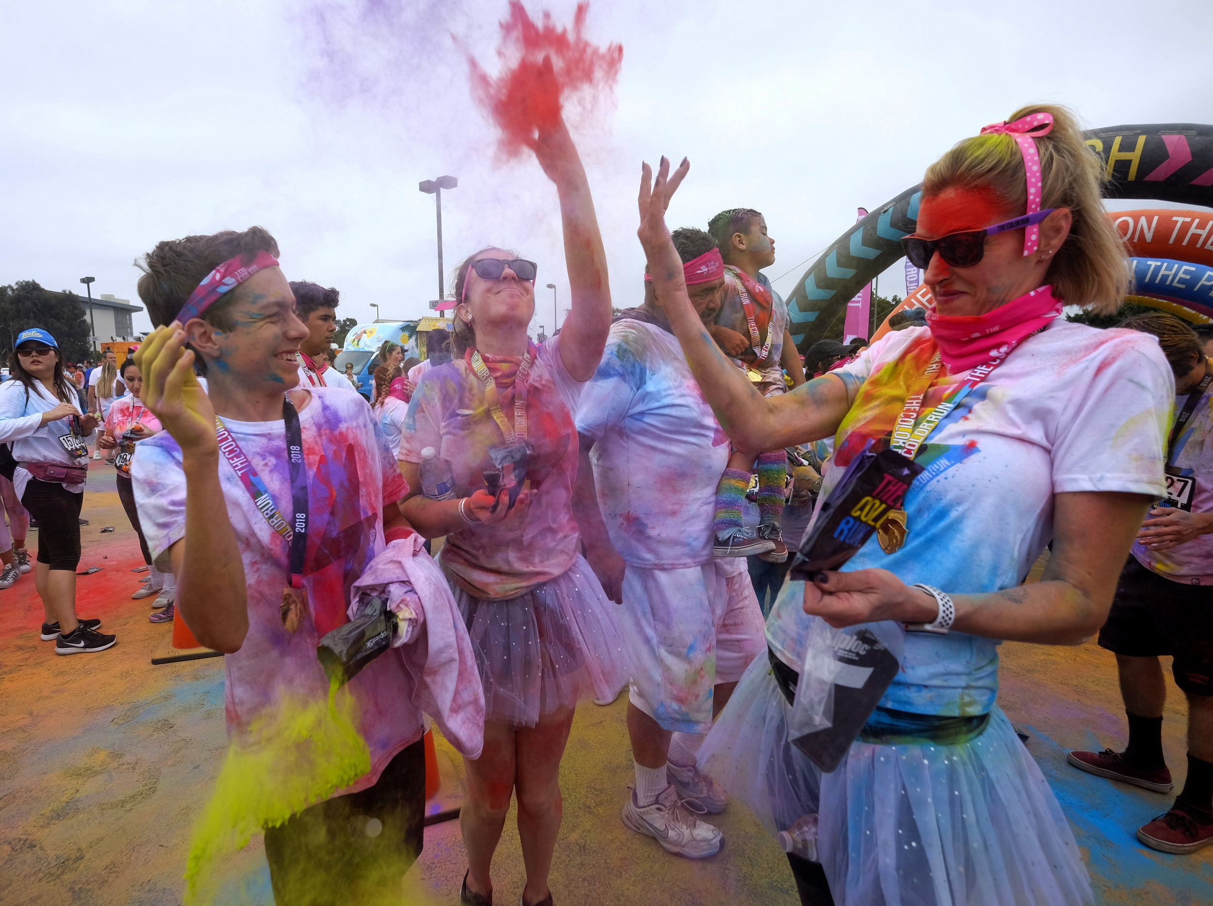  Runners revel while running through clouds of colorful powder thrown by volunteers in the Color Run at the StubHub Center in Los Angeles, United States, June 23, 2018.  