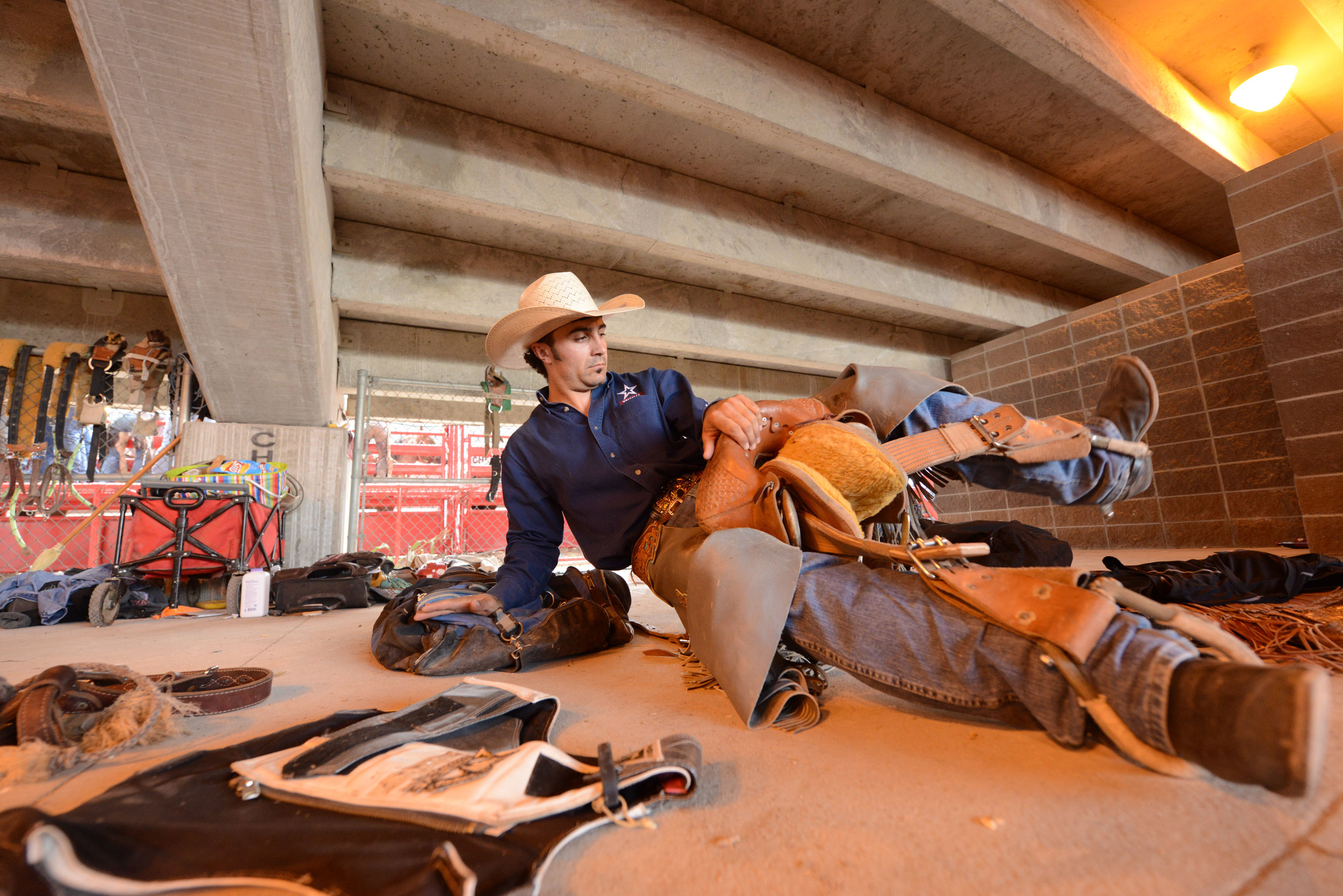  Saddle bronc rider Mitch Pollack, from Twin Falls, Idaho, prepares for his event behind the bucking chutes during the 6th performance at the 122nd Cheyenne Frontier Days Rodeo at Frontier Park in Cheyenne, Wyoming Wednesday, July 25, 2018.  