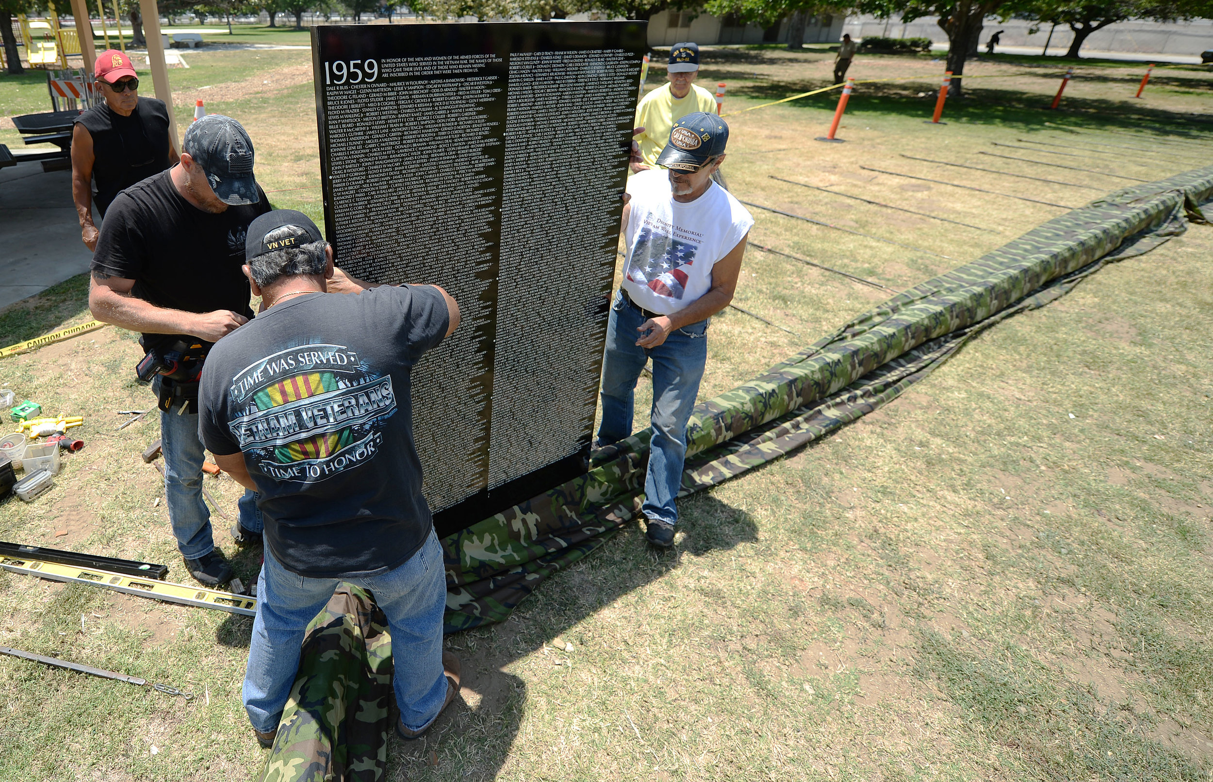 Volunteers install the first of 70 panels of the Vietnam Moving Wall Thursday at Ayala Park in Bloomington. Volunteers, many being Vietnam veterans, helped construct the Vietnam Moving Wall in Ayala Park in Bloomington Thursday June 7, 2018. The wal