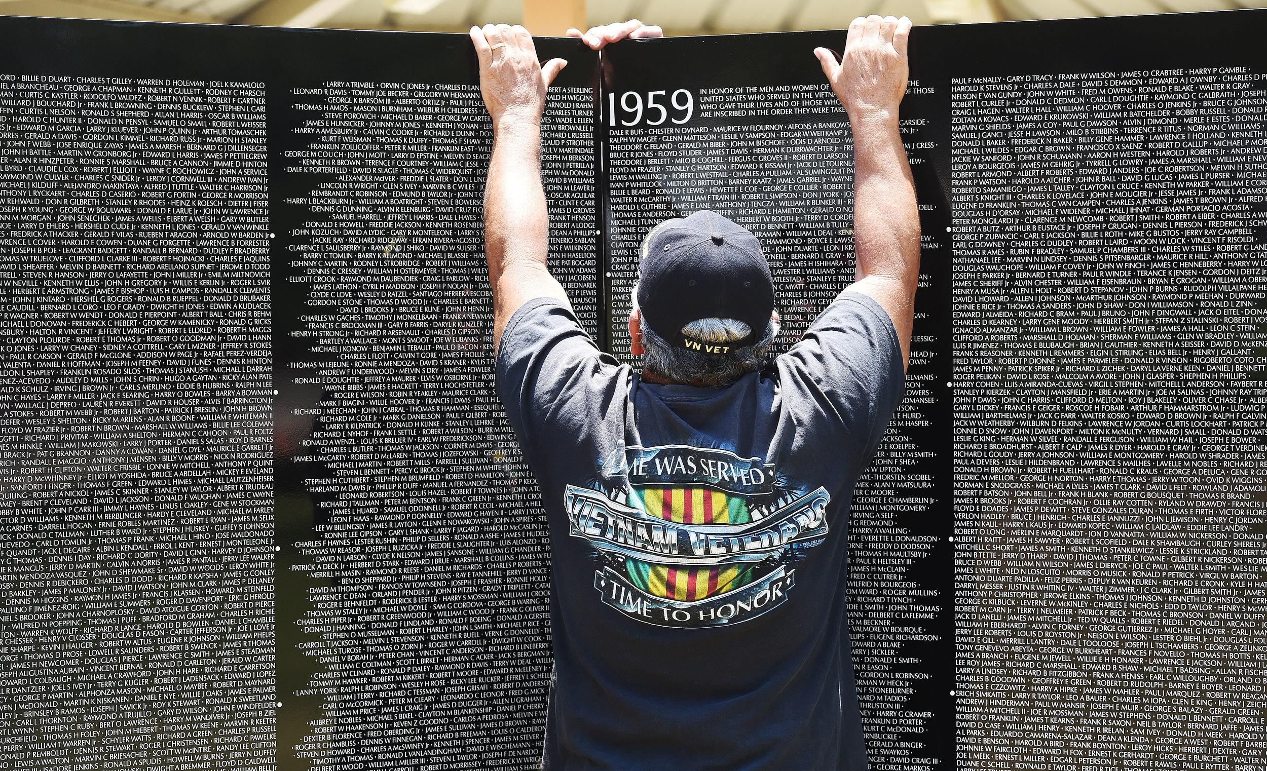  Vietnam Marine veteran Ruben Luis, 69 from San Bernardino, helps install the first two panels of the Vietnam Moving Wall Thursday at Ayala Park in Bloomington. Volunteers, many being Vietnam veterans, helped construct the Vietnam Moving Wall in Ayal