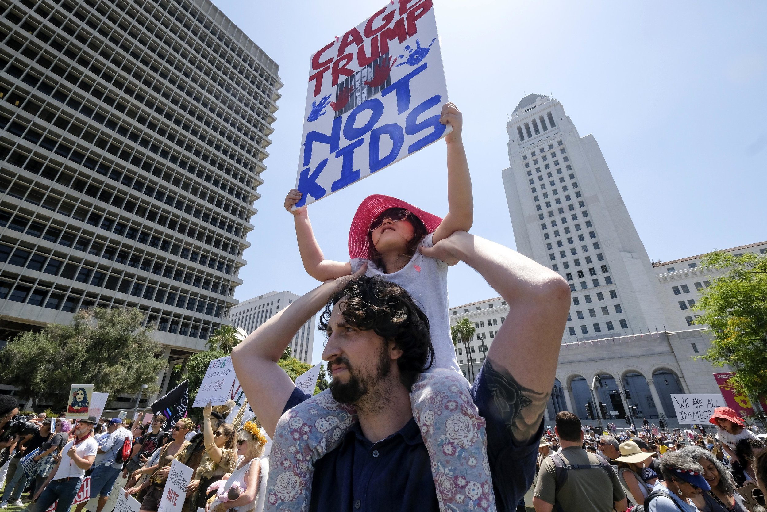  Demonstrators holding signs march against the separation of immigrant families in Los Angeles, the United States, on June 30, 2018. It's one of 600-plus marches to be held across the country to demand an end to separating and detaining families. 