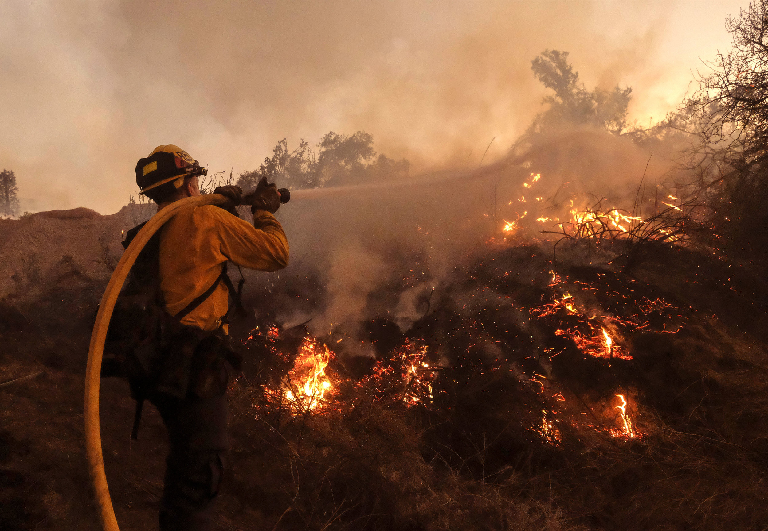  A firefighter battles the Holy Fire burning in the Cleveland National Forest along a hillside at Temescal Valley in Corona, Calif., Thursday, Aug. 9, 2018. 