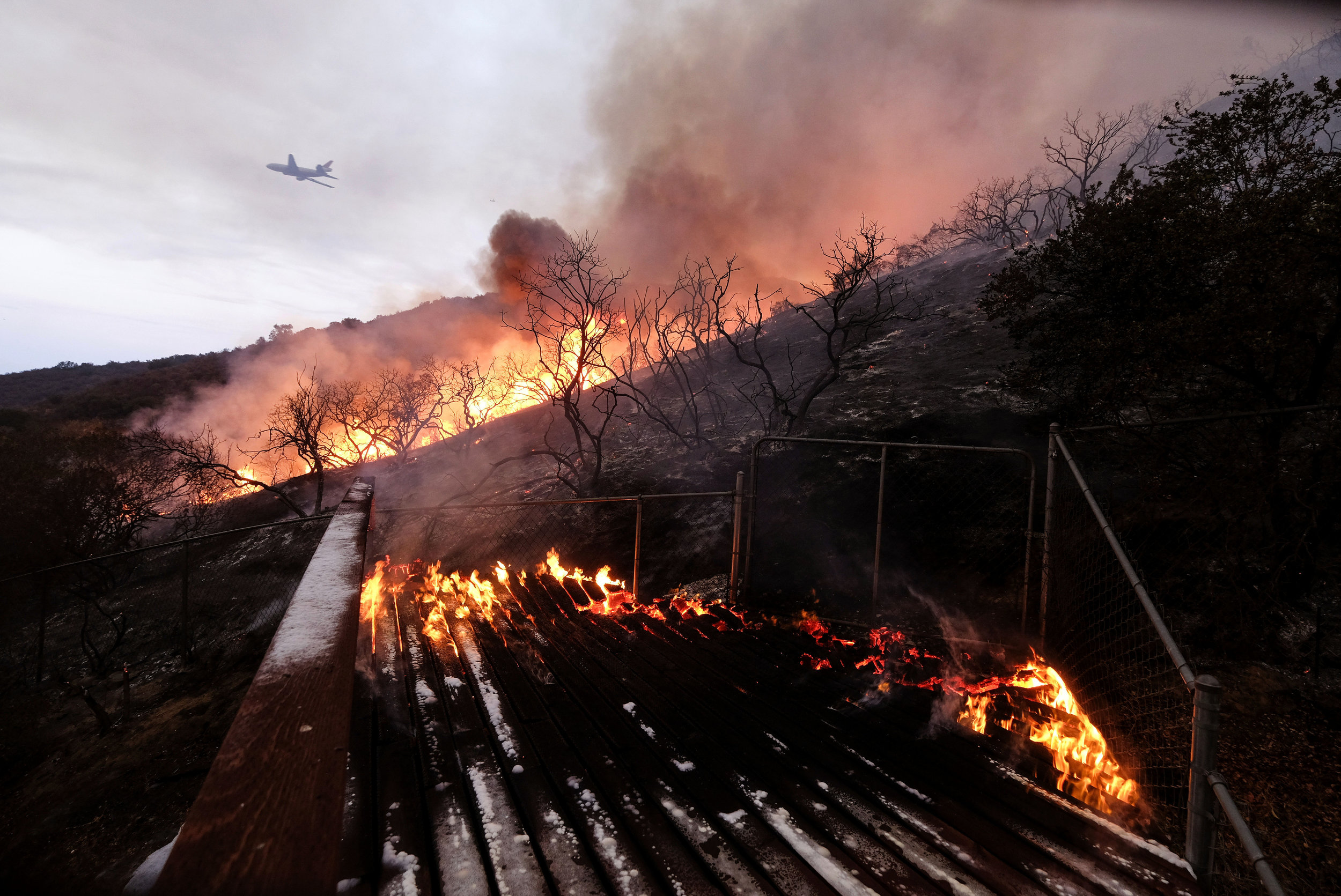  The Holy Fire burns at a home's back yard in the Cleveland National Forest in Lake Elsinore, Calif., Thursday, Aug. 9, 2018.  