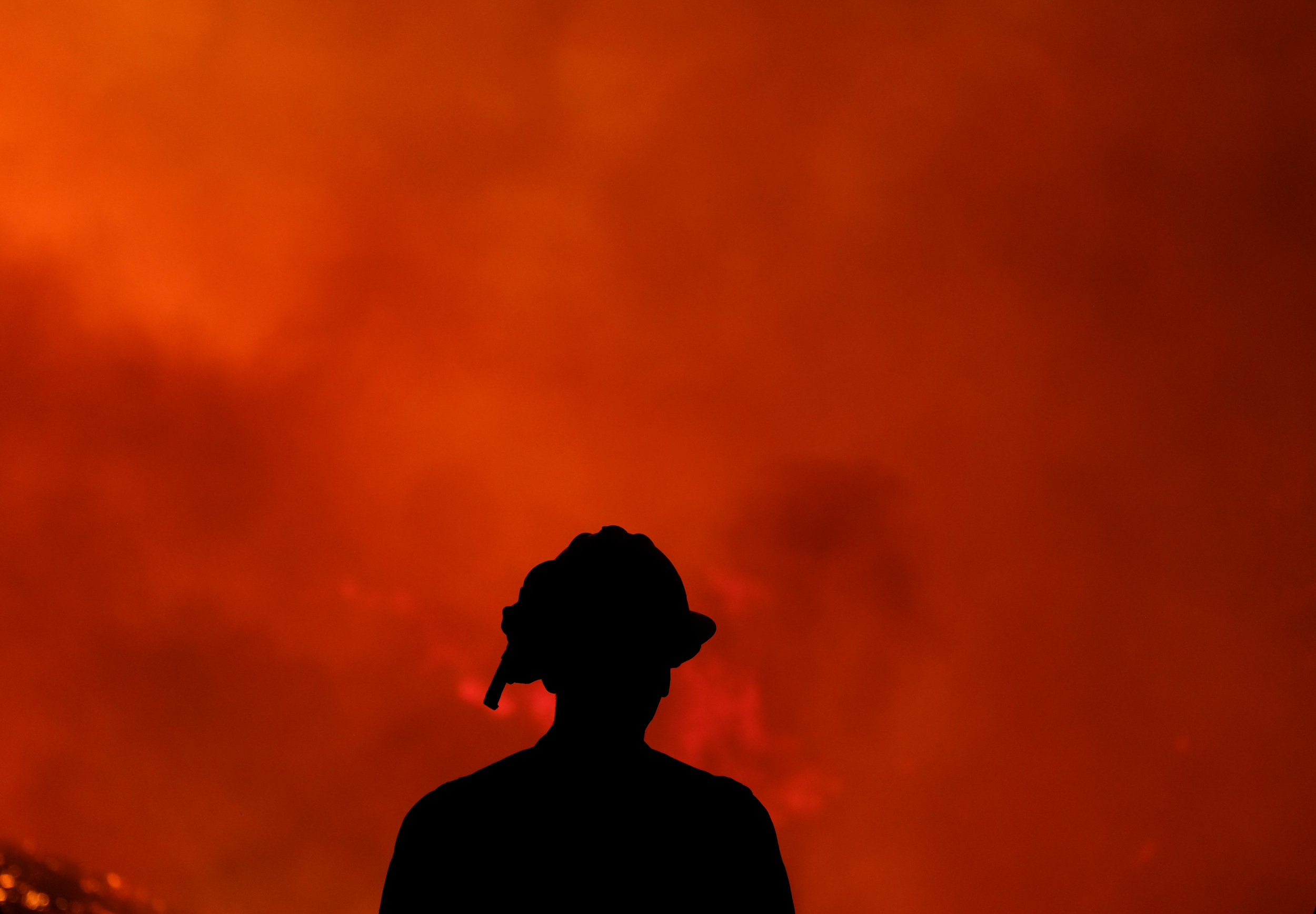  A firefighters keep watch the Holy Fire burning in the Cleveland National Forest in Lake Elsinore, Calif., Thursday, Aug. 9, 2018. 