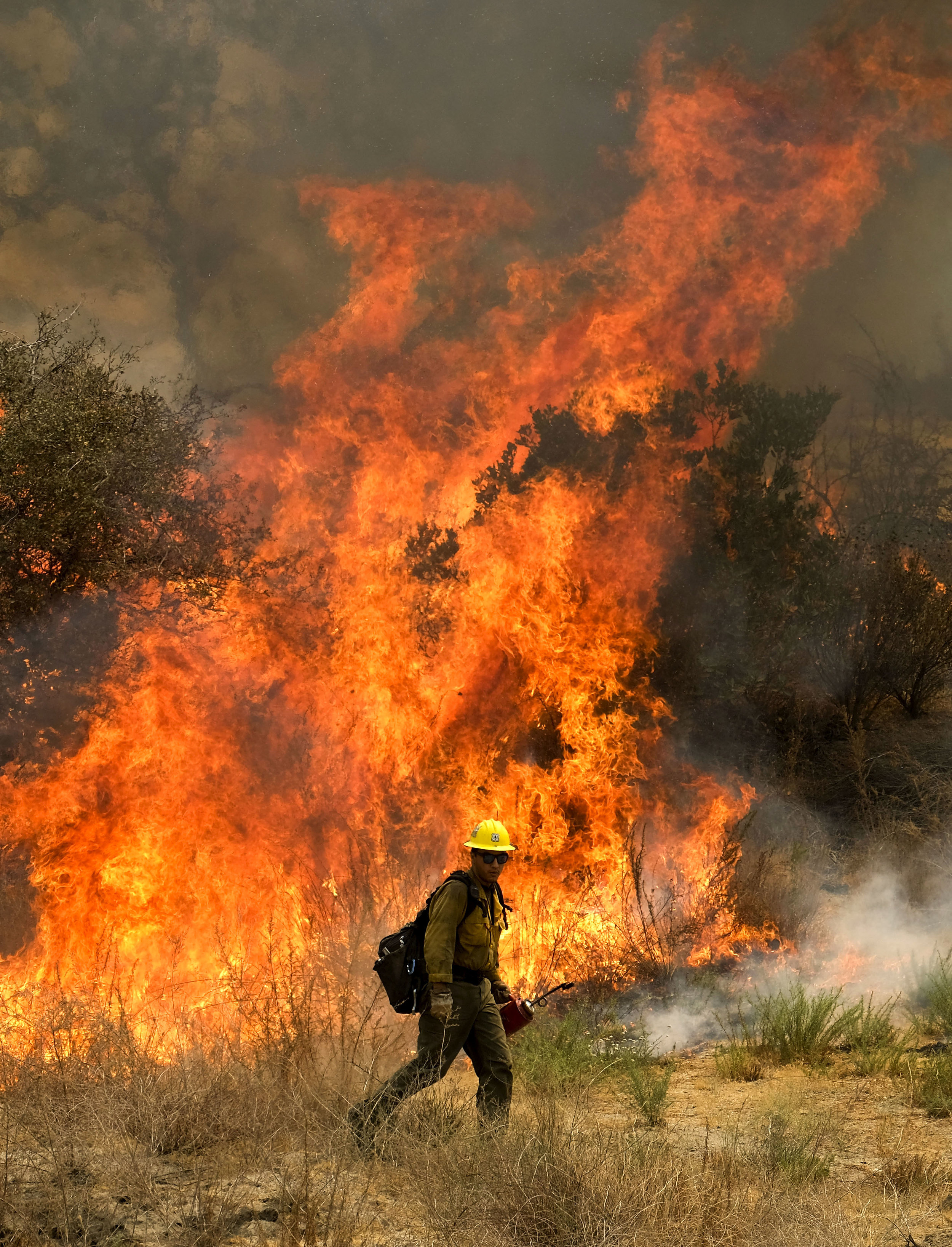  A firefighter battles the Holy Fire burning in the Cleveland National Forest in Lake Elsinore, California on Friday, Aug. 10, 2018.  