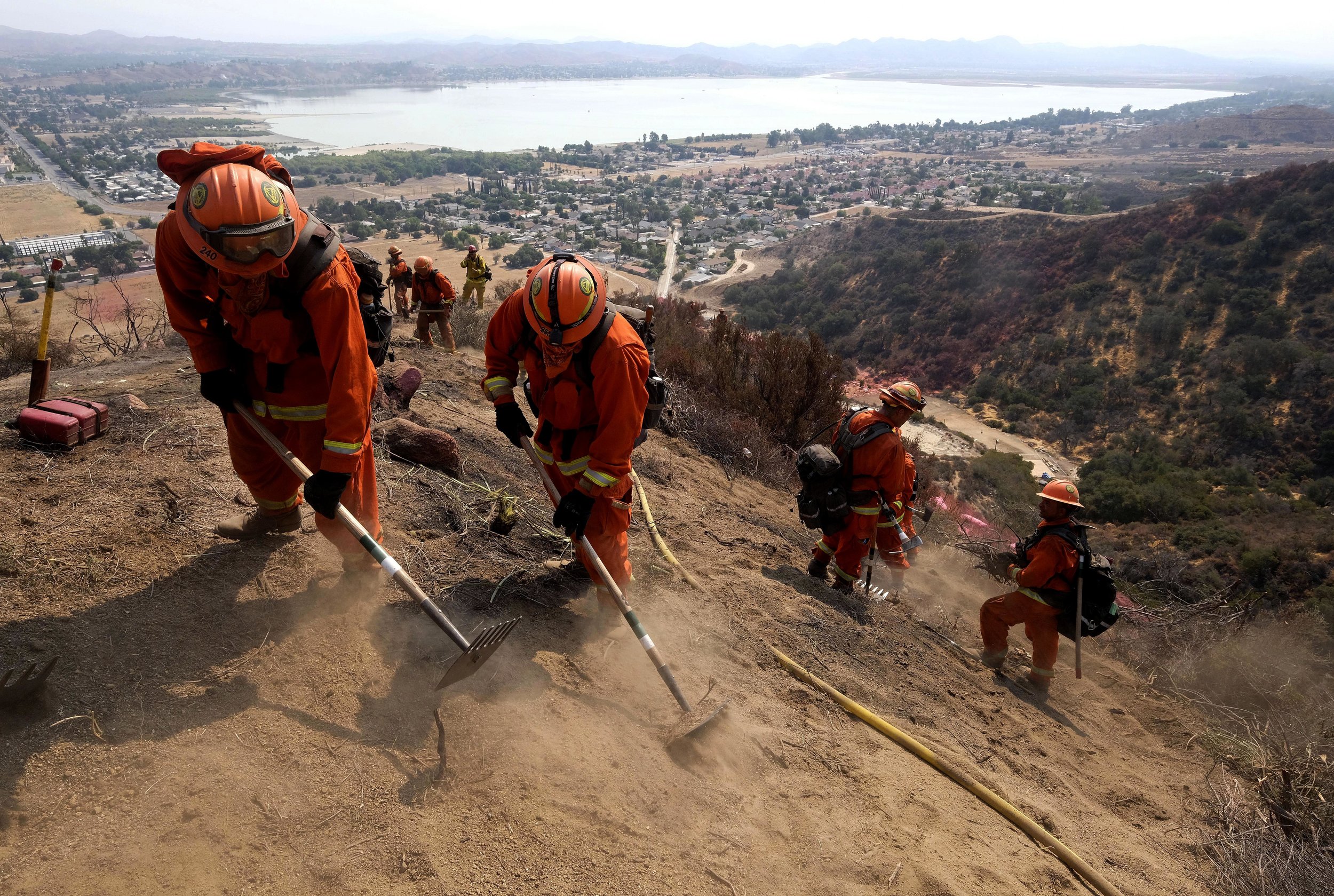  Hand crews work on the fire line at the Holy Fire in Lake Elsinore, California, southeast of Los Angeles, on August 11, 2018. The fire has burned 21,473 acres and was 29 percent contained as of 8:30 a.m. Saturday, according to the Cleveland National