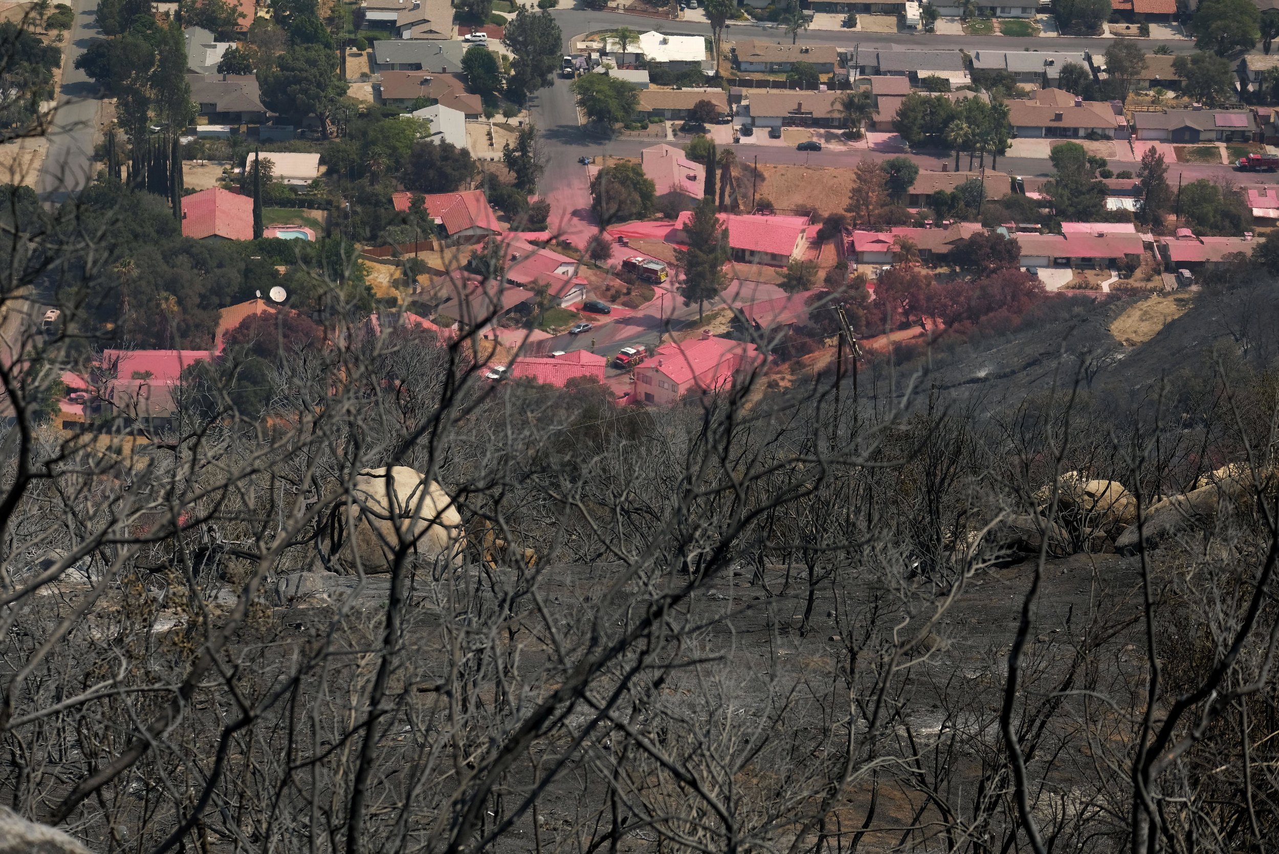  Homes are covered in pink fire retardant at the Holy Fire in Lake Elsinore, California, southeast of Los Angeles, on August 11, 2018. The fire has burned 21,473 acres and was 29 percent contained as of 8:30 a.m. Saturday, according to the Cleveland 