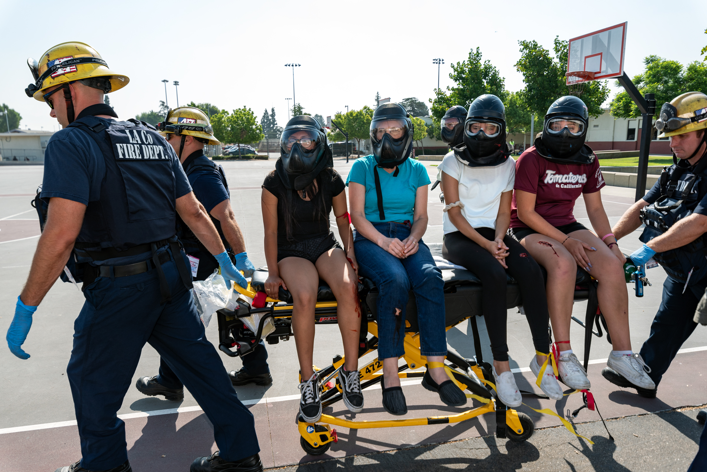 Firefighters transport students on a gurney during an active sho